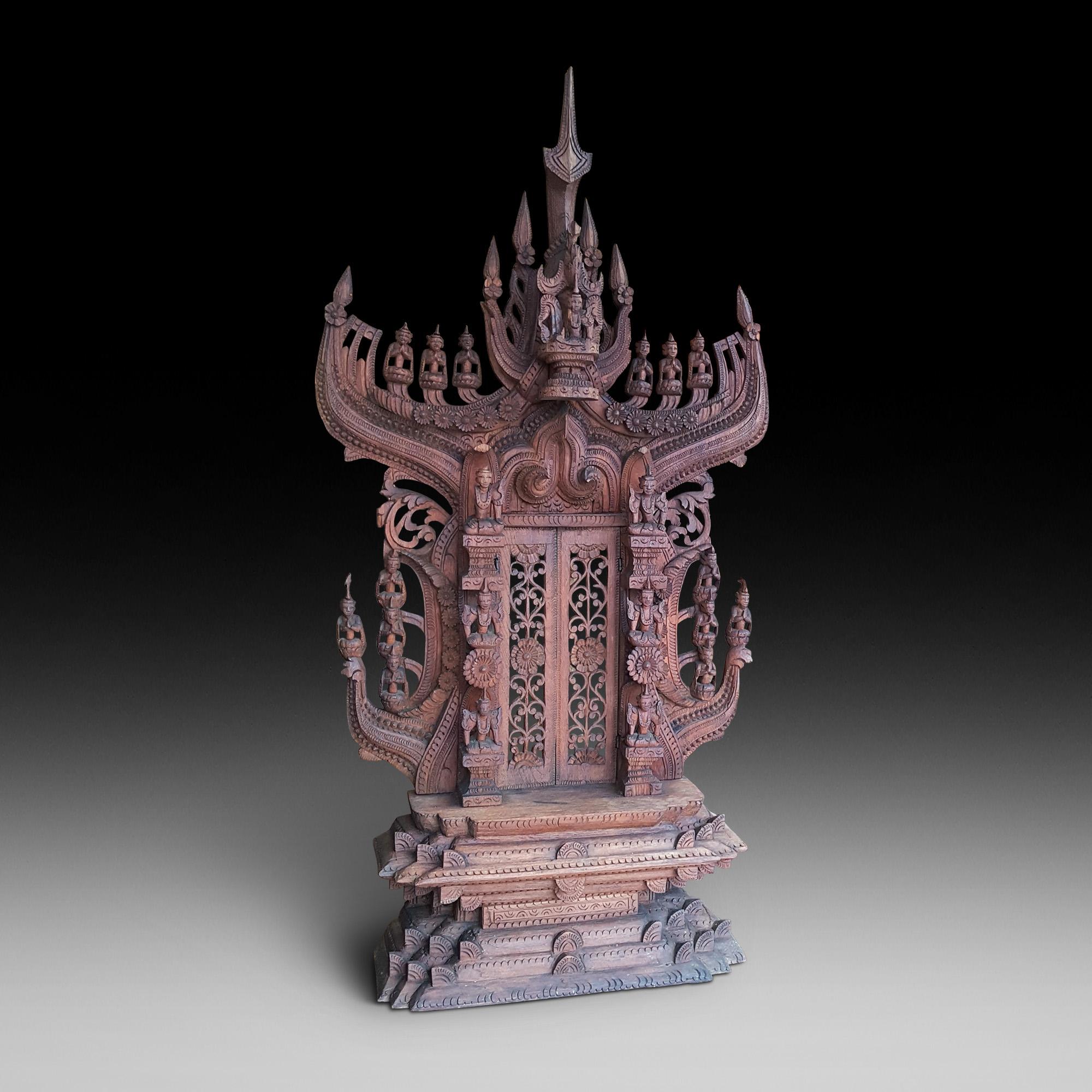 Set of late 19th century Indonesian wood carvings of Budhist temple, Shrine, Guardian and calling gong flanked by a pair of Guardians
Gong 18