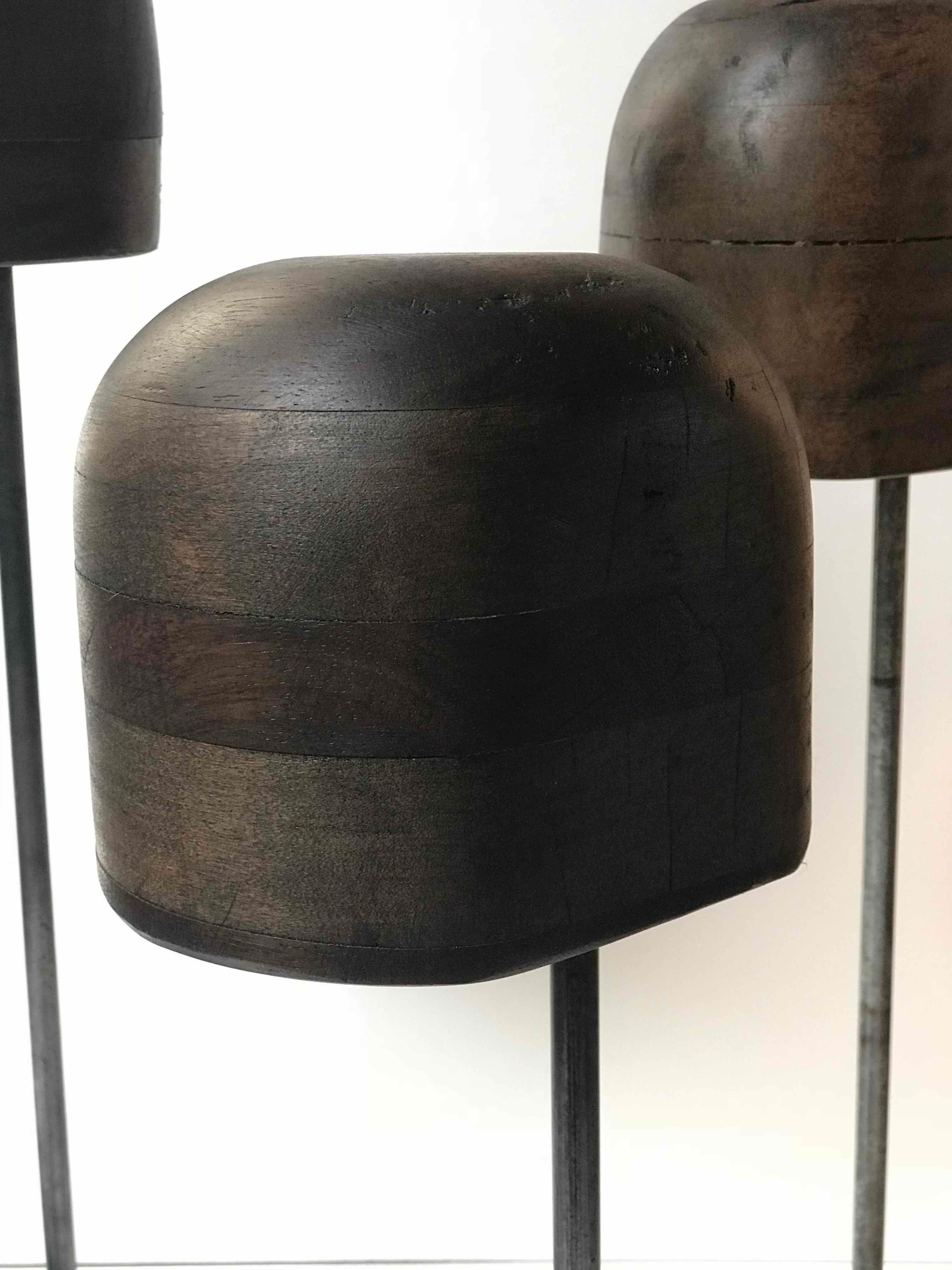 Set of late 19th century wooden hat stands on iron bases from England. 