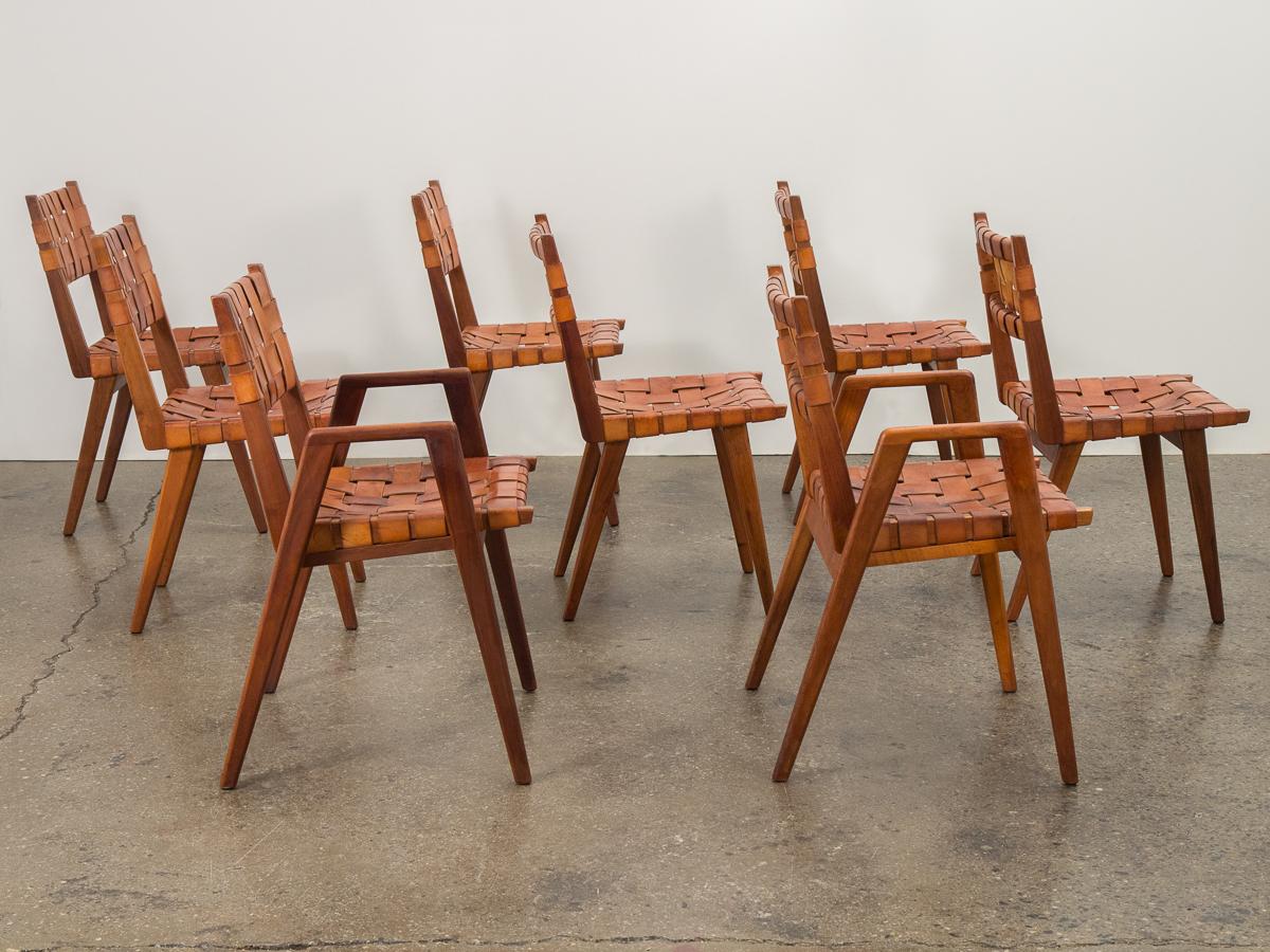 Classic set of dining chairs with woven leather seat, designed by Mel Smilow for Smilow-Thiele. Sculpted walnut wood frames are gleaming and crafted with an eye to detail as seen in their beautiful joinery. Cognac leather seats are supple and