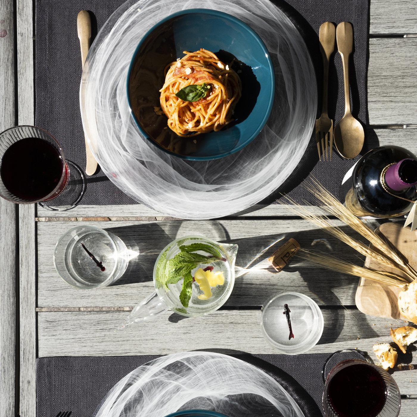 This tableware collection brings a piece of the ocean into the home. At the bottom of each glass and matching pitcher, a delicate rich red glass fish floats on a thin glass support, creating a unique illusion. The tall jug has an elegant shape and a