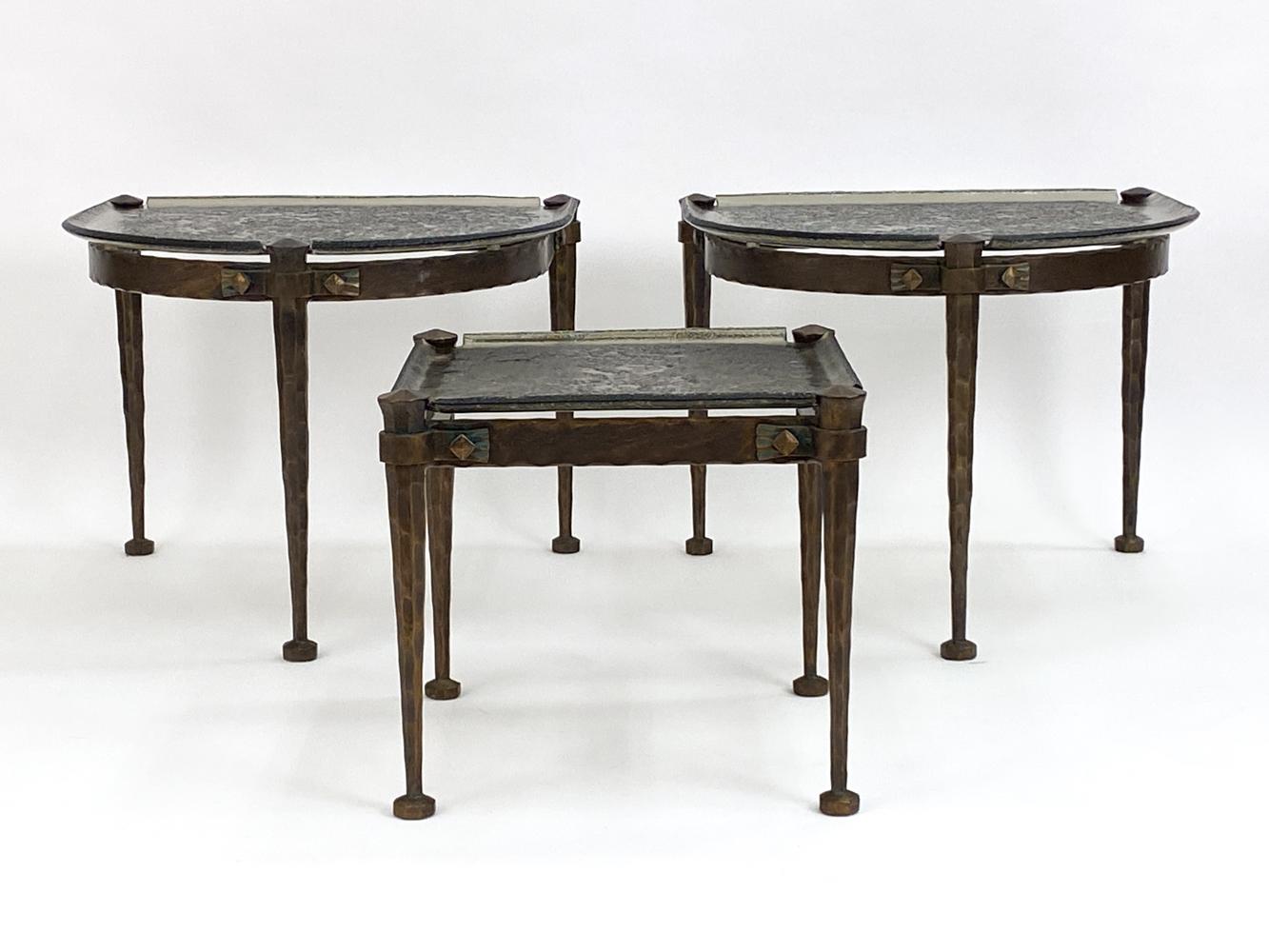 This rare set of Brutalist style bronze round coffee tables was designed by German designer Lothar Klute. Each coffee table features a wrought bronze frame with natural patina, tapered legs, and square feet. A gorgeous geometric design in etched