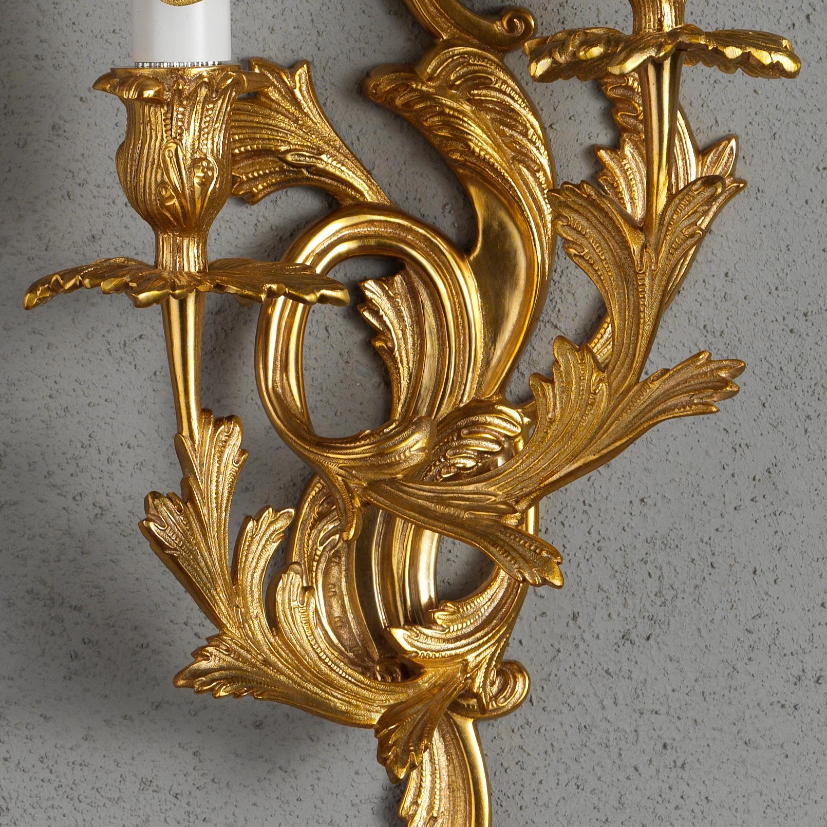 A fine set of French Louis XV style gilt bronze sconces By Gherardo Degli Albizzi Beautifully cast in the traditional manner with all the sumptuous movement of the Rococo period, having two arms issuing from the plate and adorned with acanthus