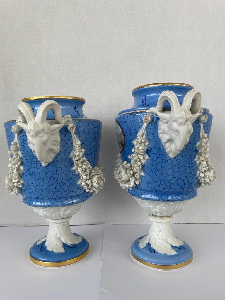 This stylish set of two porcelain vases are in the Louis XVI style of the late 18th century, and are very much in the manner of pieces created by Sevres. 

Note: The two pieces vary slightly in their dimensions.
 One vase measures 8.75