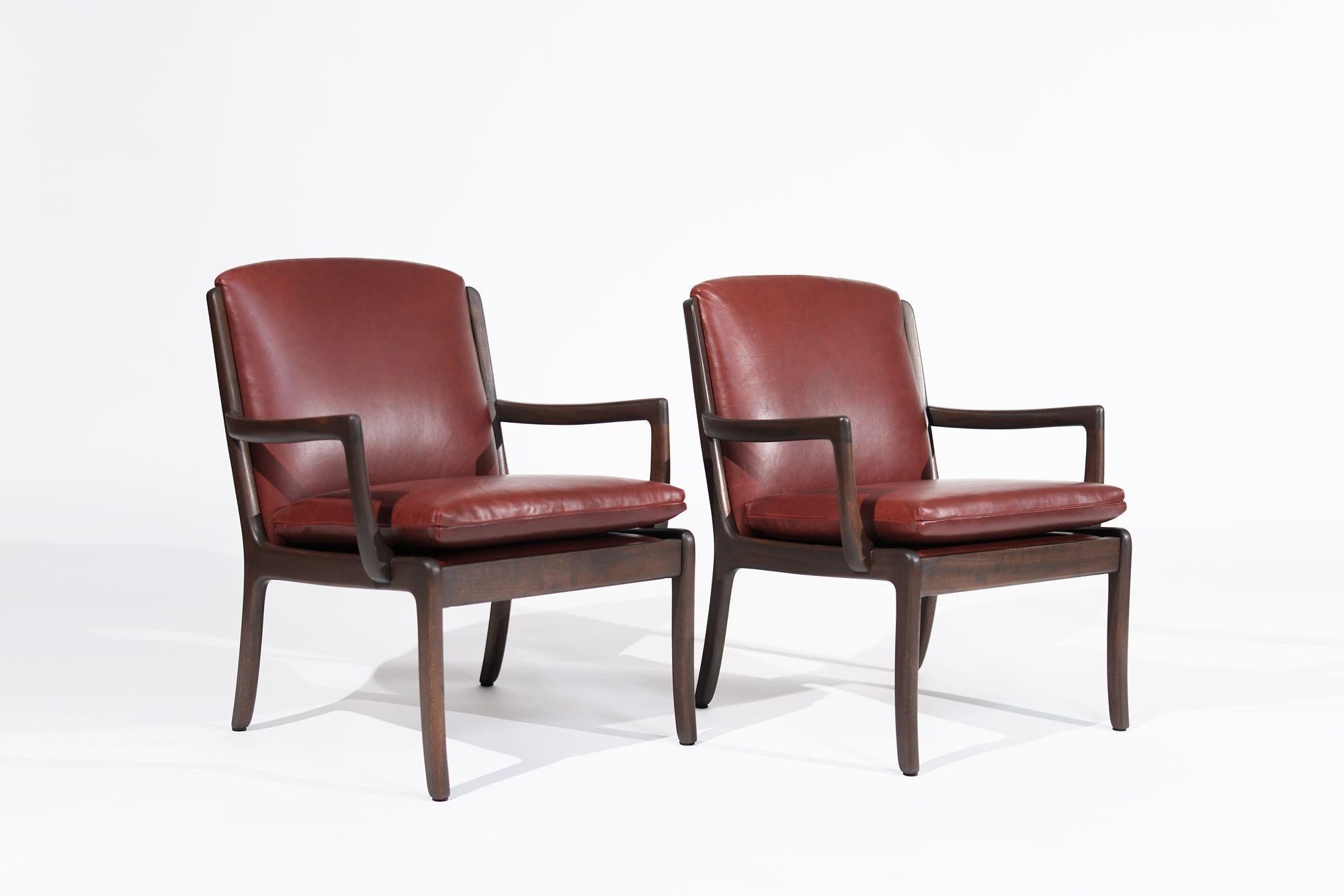 An exquisite set of Scandinavian Modern lounge chairs by renowned Danish designer Ole Wanscher for Cado. Crafted from rich mahogany, these chairs exude sophistication and elegance. Painstakingly restored to their original glory and reupholstered in