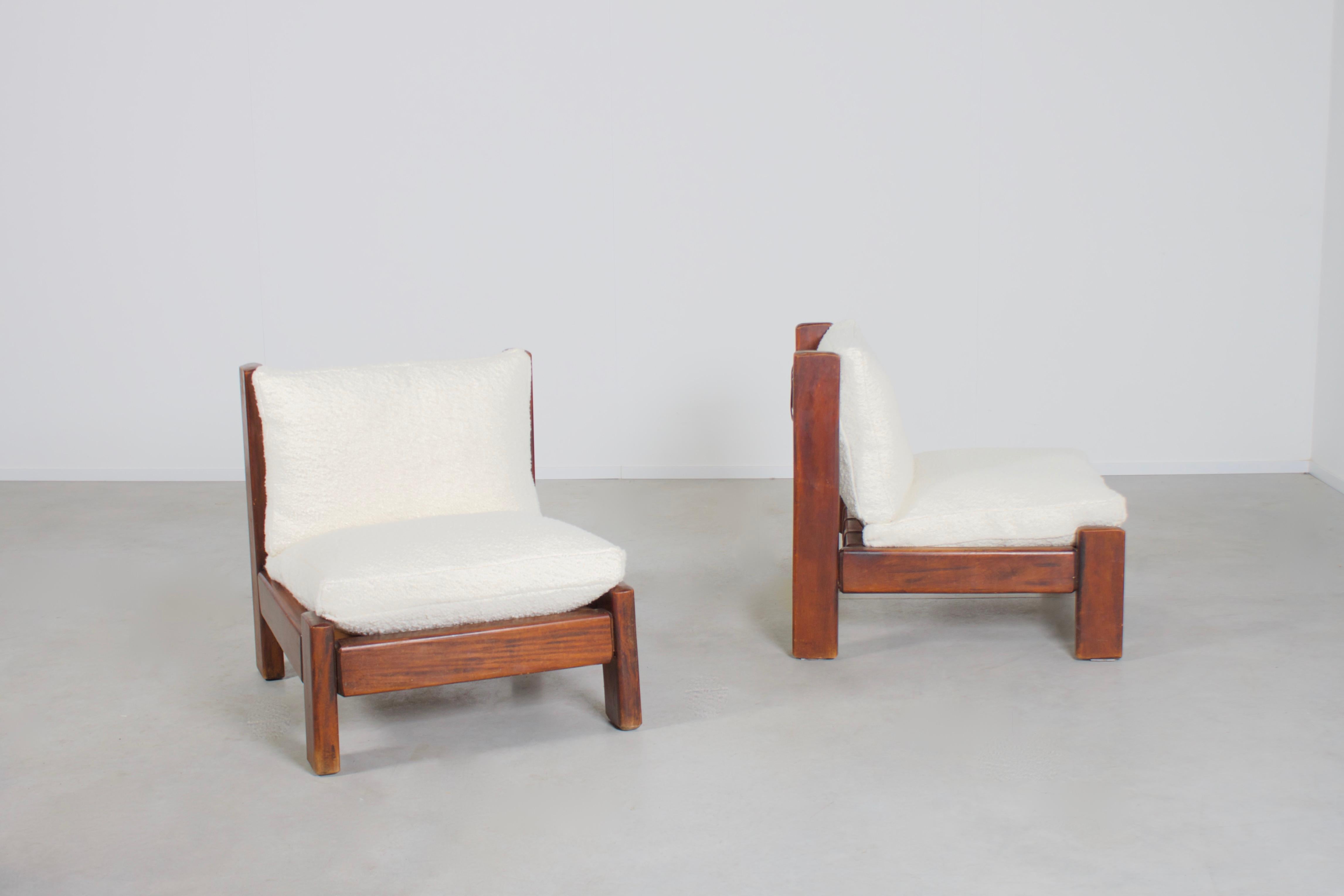Set of low Brazilian lounge chairs in good condition.

Designed in the 1960s

These chairs have a solid tropical hardwood frame which has leather straps spanned to support the 
back cushion.

The seat and the back cushions have a loose character and
