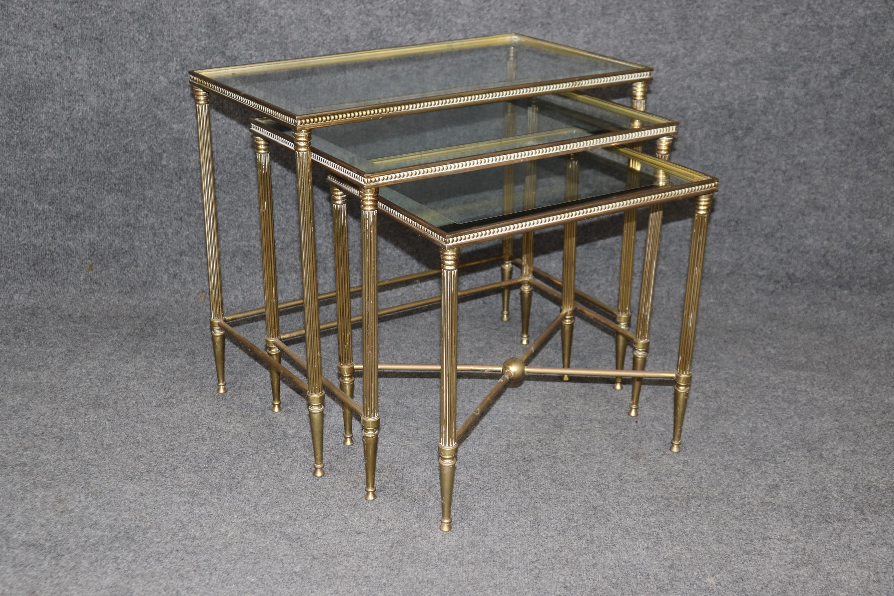 Dimensions (Largest table) - H: 20 1/2 in W: 23 1/4 in D: 13 3/4 in

This set of Maison Jansen nesting tables were made with one thing in mind.... Quality! This set is equipped with the original glass with mirrored borders around each piece and the