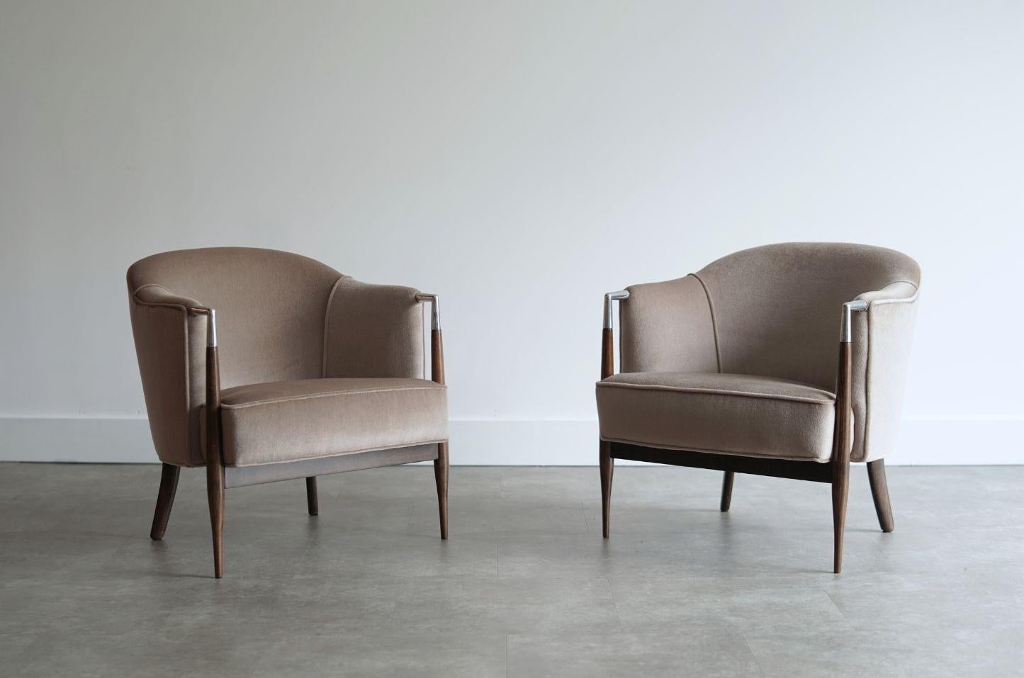 Set of vintage lounge chairs, original from the 1960s, fully restored by Stamford Modern. These striking chairs feature distinctive polished nickel arm details that contrast beautifully with the dark walnut frame. The walnut wood has been expertly