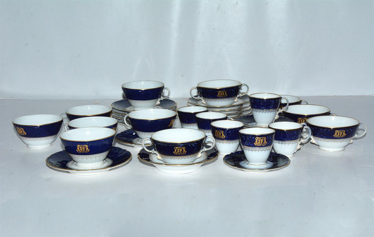 Entertain in style with this 78 piece of elegant cobalt blue and white porcelain china made in England or France possibly in the 1840s or 1850s when there was a revival in the Rococo style. The pure white porcelain is of the finest and hardest made