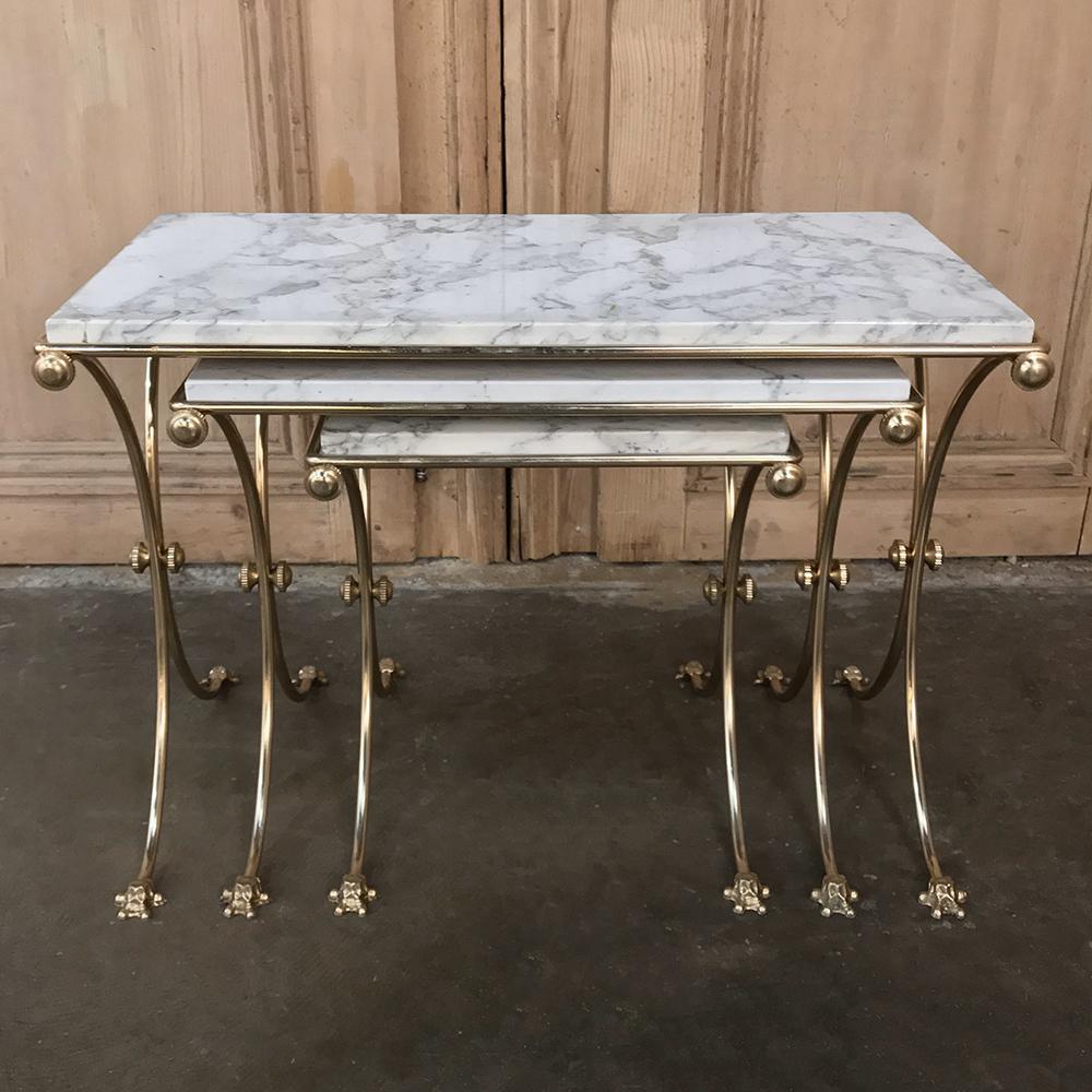 Set of midcentury brass and marble nesting tables features classical lines inspired by ancient Egyptian architecture rendered in brass supporting beautifully veined marble for carefree elegance,
circa 1950s
Largest measures 17 H x 24 W x 14