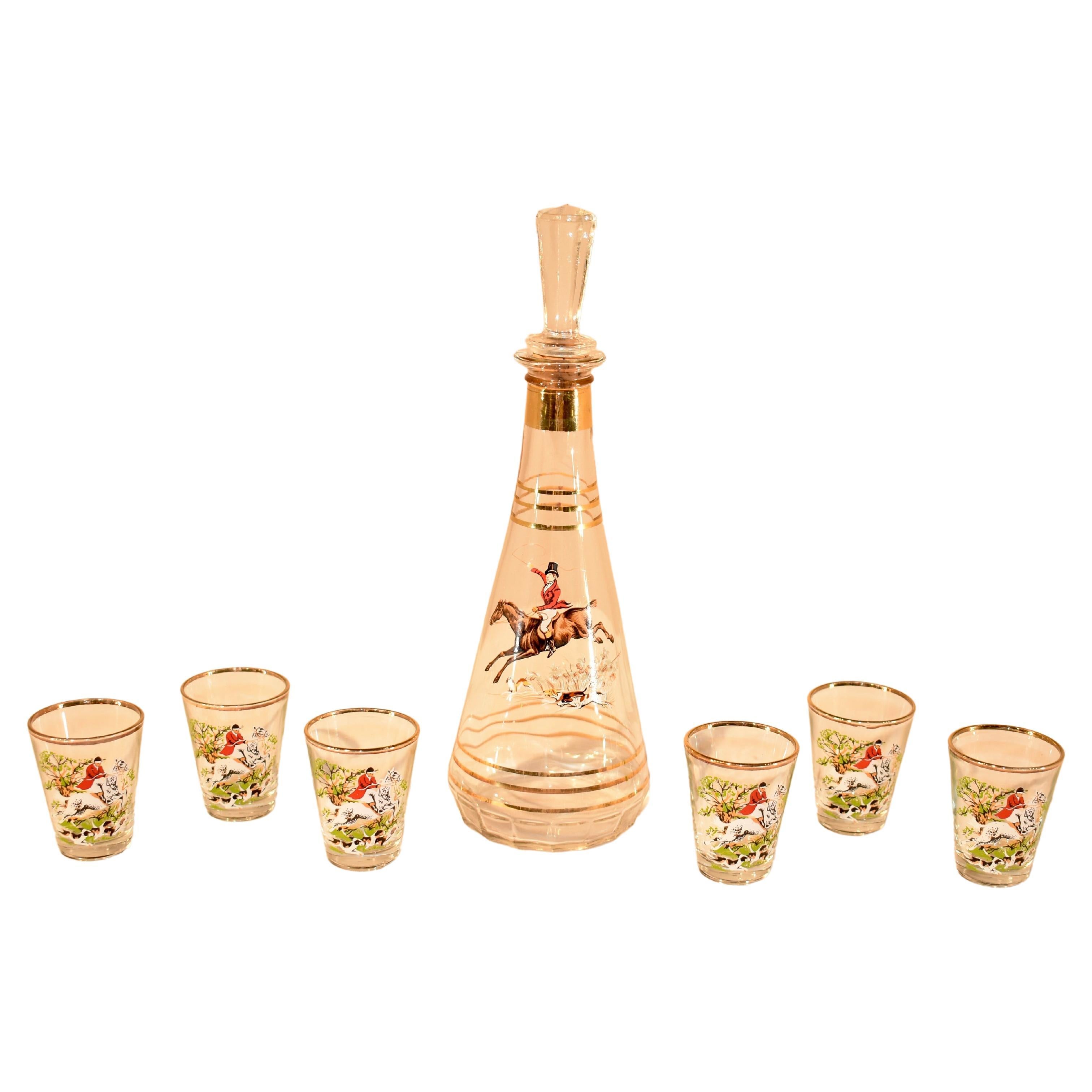 Gorgeous set of mid-century barware from England. The cordial set includes a bottle, which measures 3.5 inches x 10.5 inches and six small glasses which measure 1.88 inches x 2.25 inches. The set has the original box and is hand painted with hunting