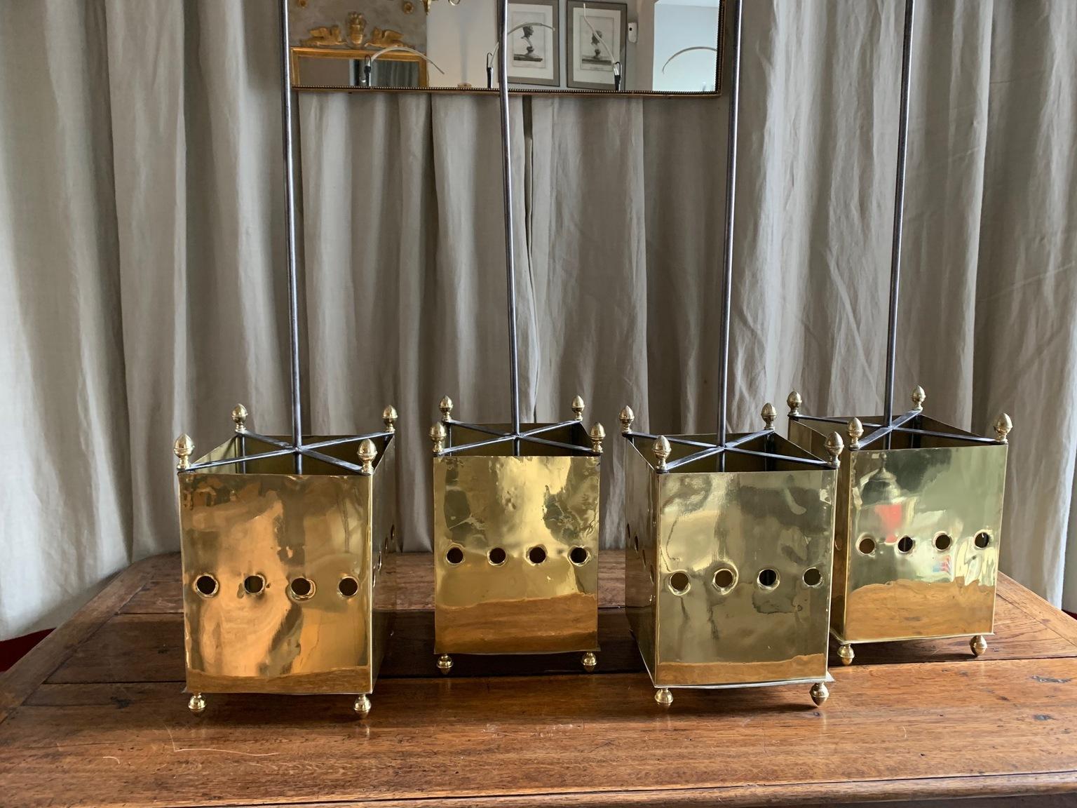 Set of two midcentury lanterns, with a neoclassical design with very current lines in solid brass, the lanterns have been restored to return to their original color and tone, it consists of a central part decorated with holes and edges finished in a
