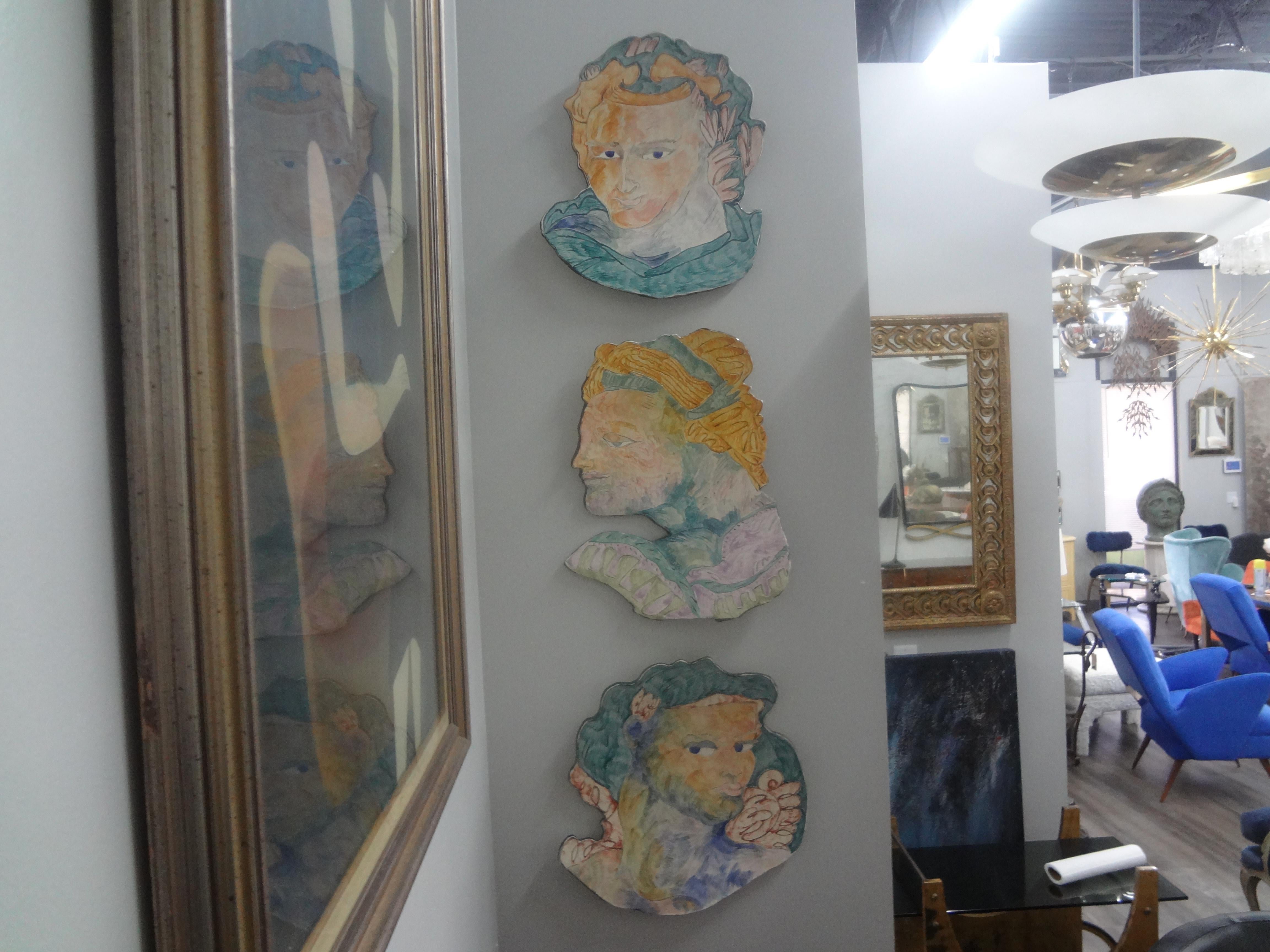 Set Of Mid Century Glazed Ceramic Wall Plaques.
This unique set of three hand made and decorated glazed ceramic wall sculptures or wall chargers depict classical Greek heads executed in soft pastel colors.
Most unusual wall decorations!