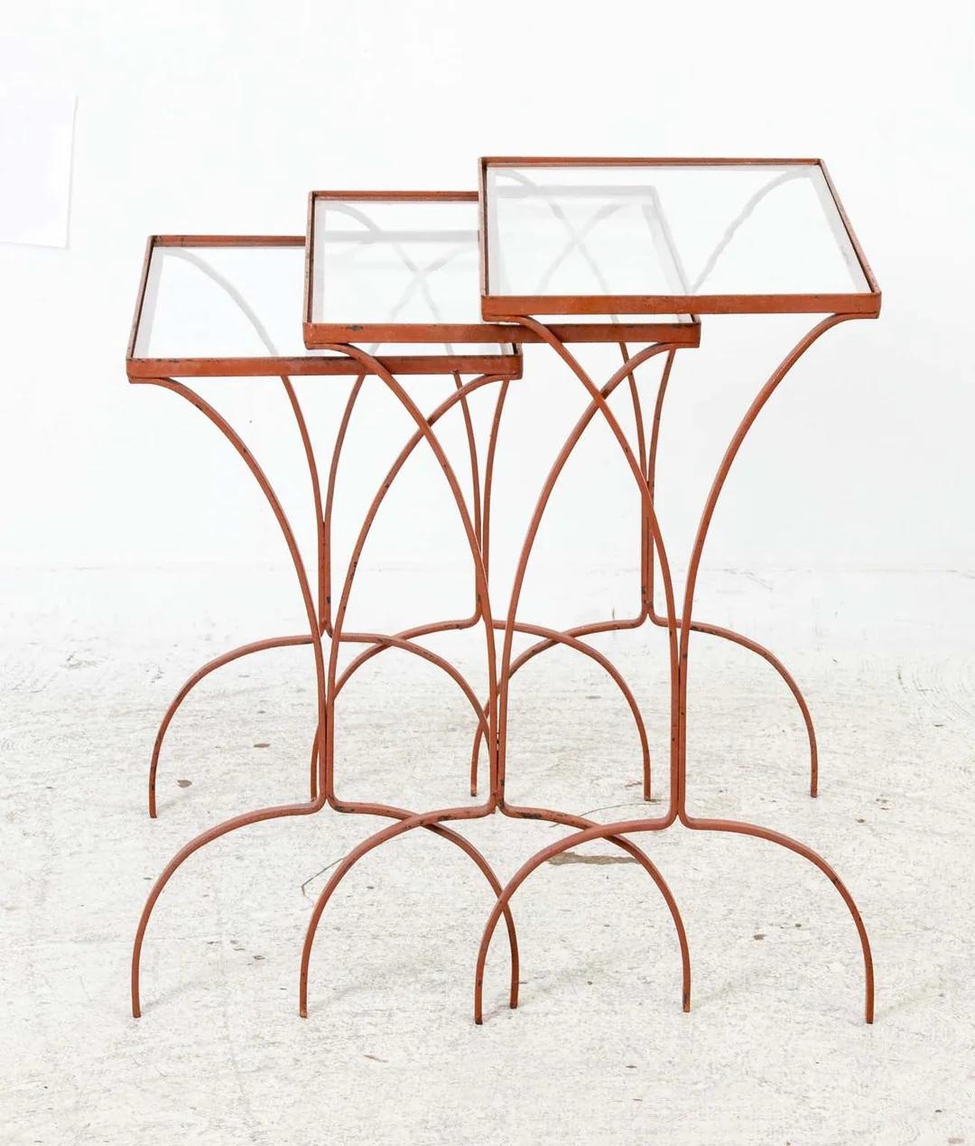 Set Of Three Mid Century Iron Nesting Tables with inset glass tops. Original painted finish and glass. Some wear to finish as shown. Glass does have some chipping. Overall  sturdy useable condition