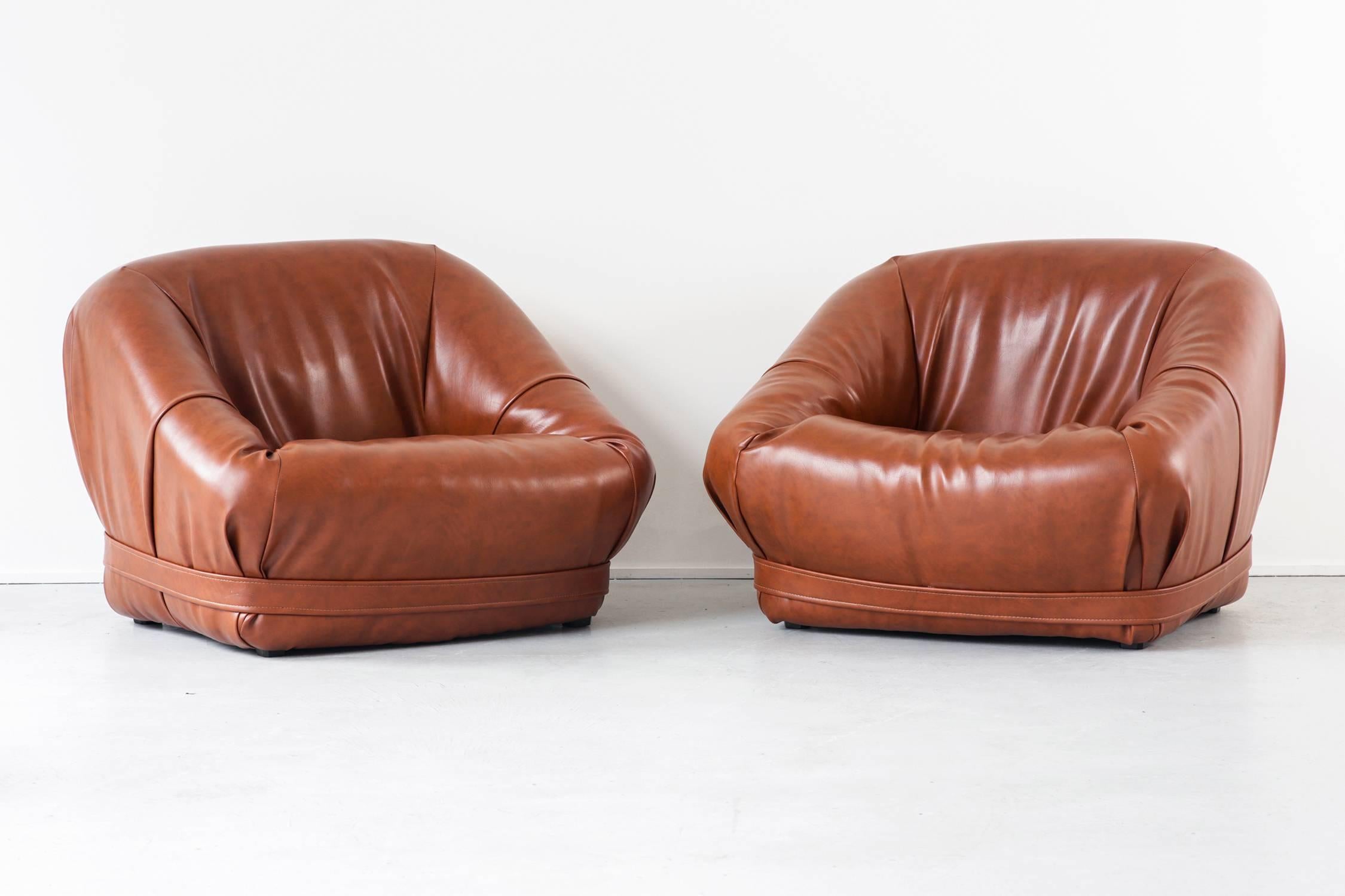 Set of two faux leather lounge chairs in the style of Percival Lafer. Excellent original condition.