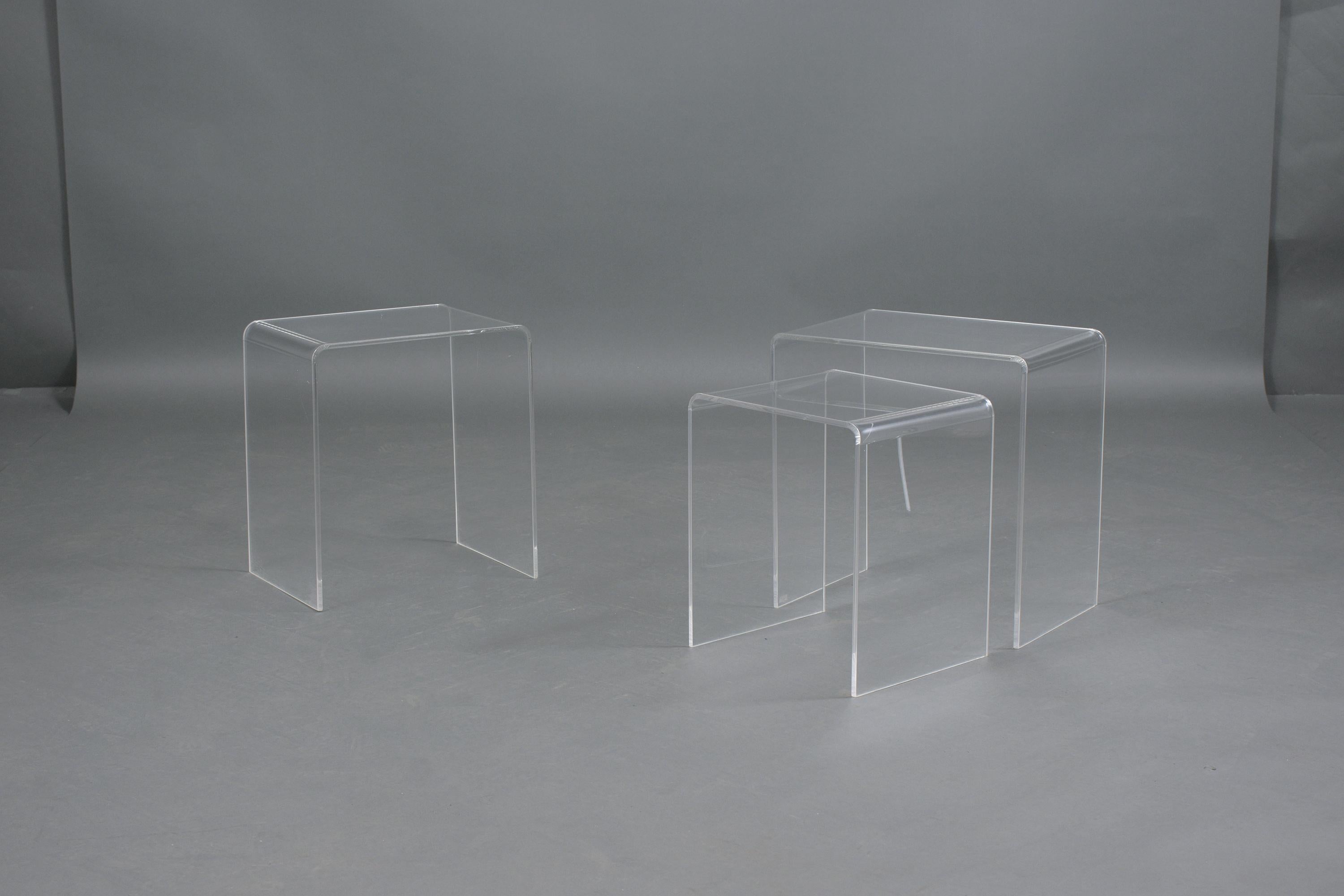 An extraordinary set of mid-century nesting tables hand-crated out of lucite. These fabulous side tables are in good condition and feature a waterfall design ready to be enjoyed and displayed for many years to come.
The dimensions on the listing are