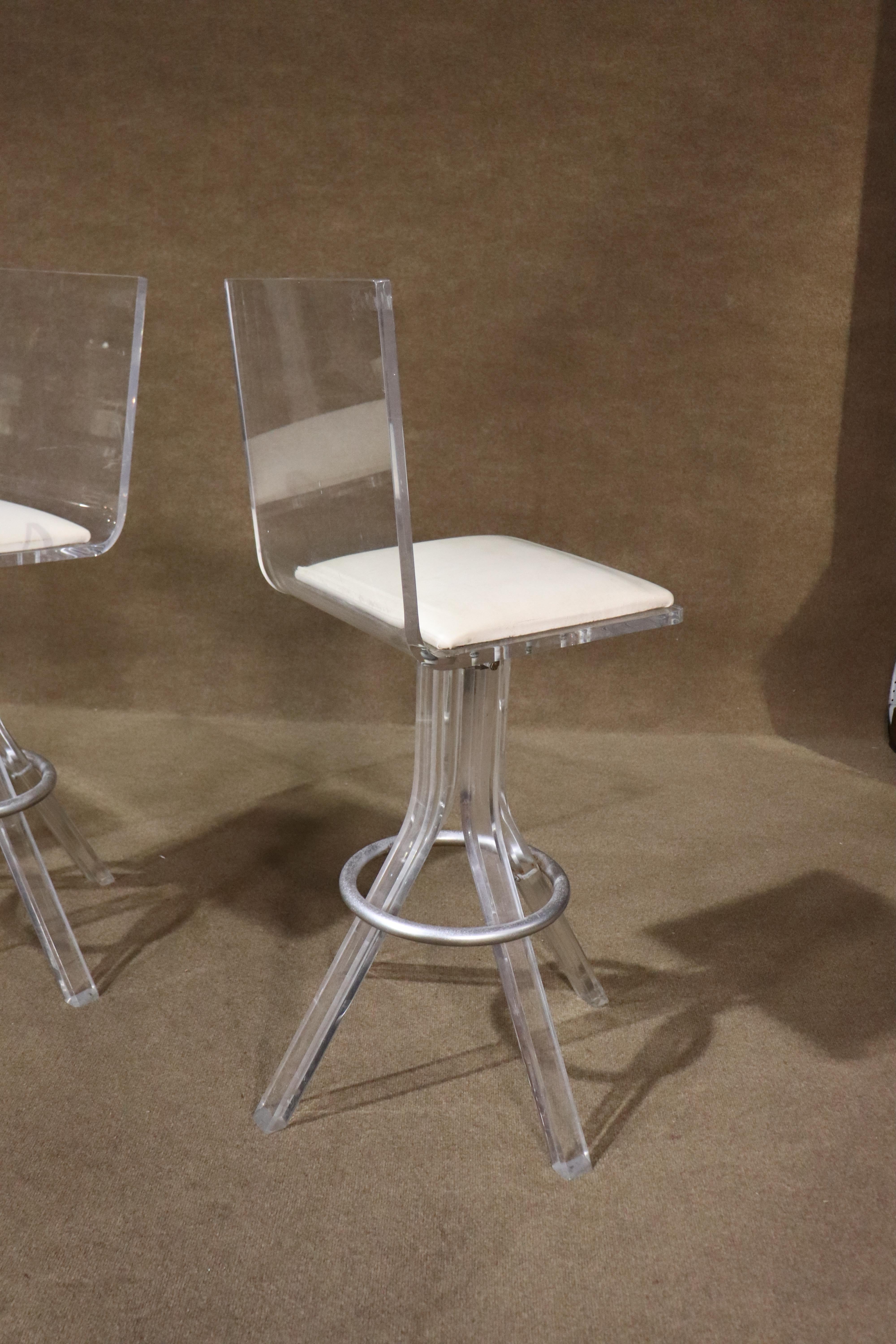 Mid-century modern clear acrylic stools with metal footrests. Vinyl cushioned seat, with four sturdy lucite legs.
Please confirm location NY or NJ
