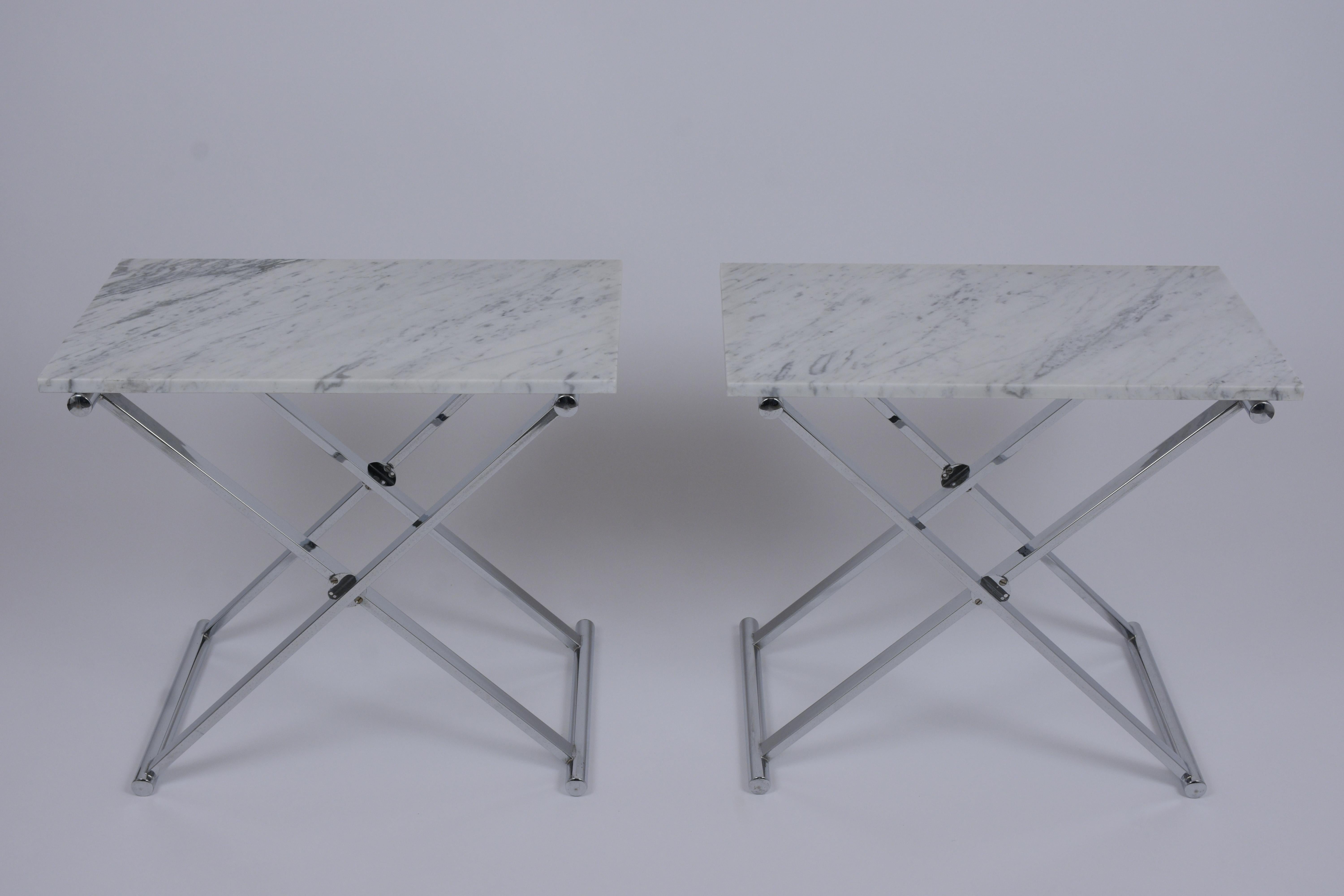 These pair of Mid-Century Modern end tables are made out of steel and marble, these sides tables feature new white Carrara marble top with flat polished edges resting on a chrome X-shaped design pedestal bases newly polished. These Sleek design