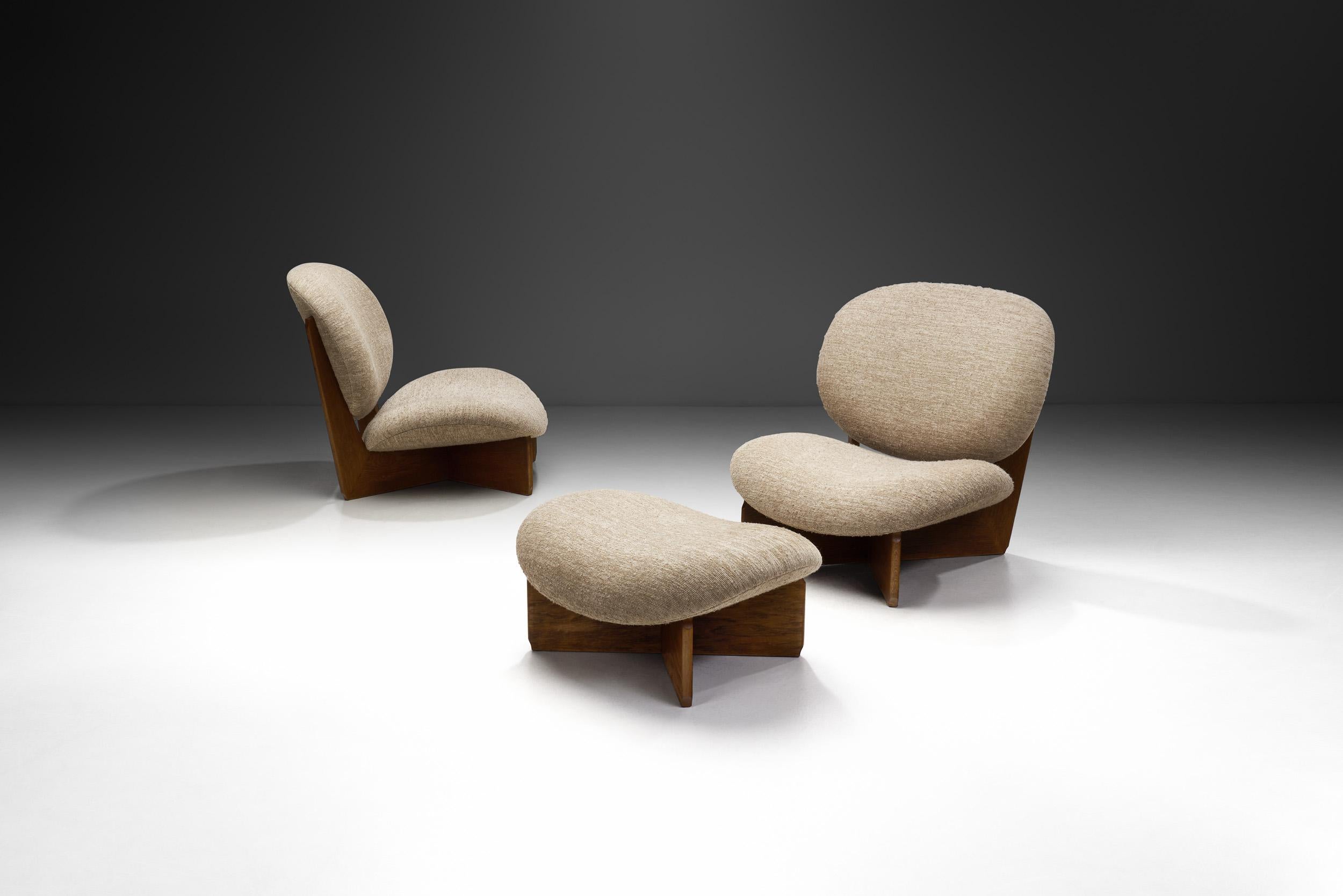 This set of lounge chairs and footstool embodies the essence of mid-century modern design, seamlessly blending elegance with functional comfort. The construction of these stunning chairs revolves around the use of high-quality materials, and the