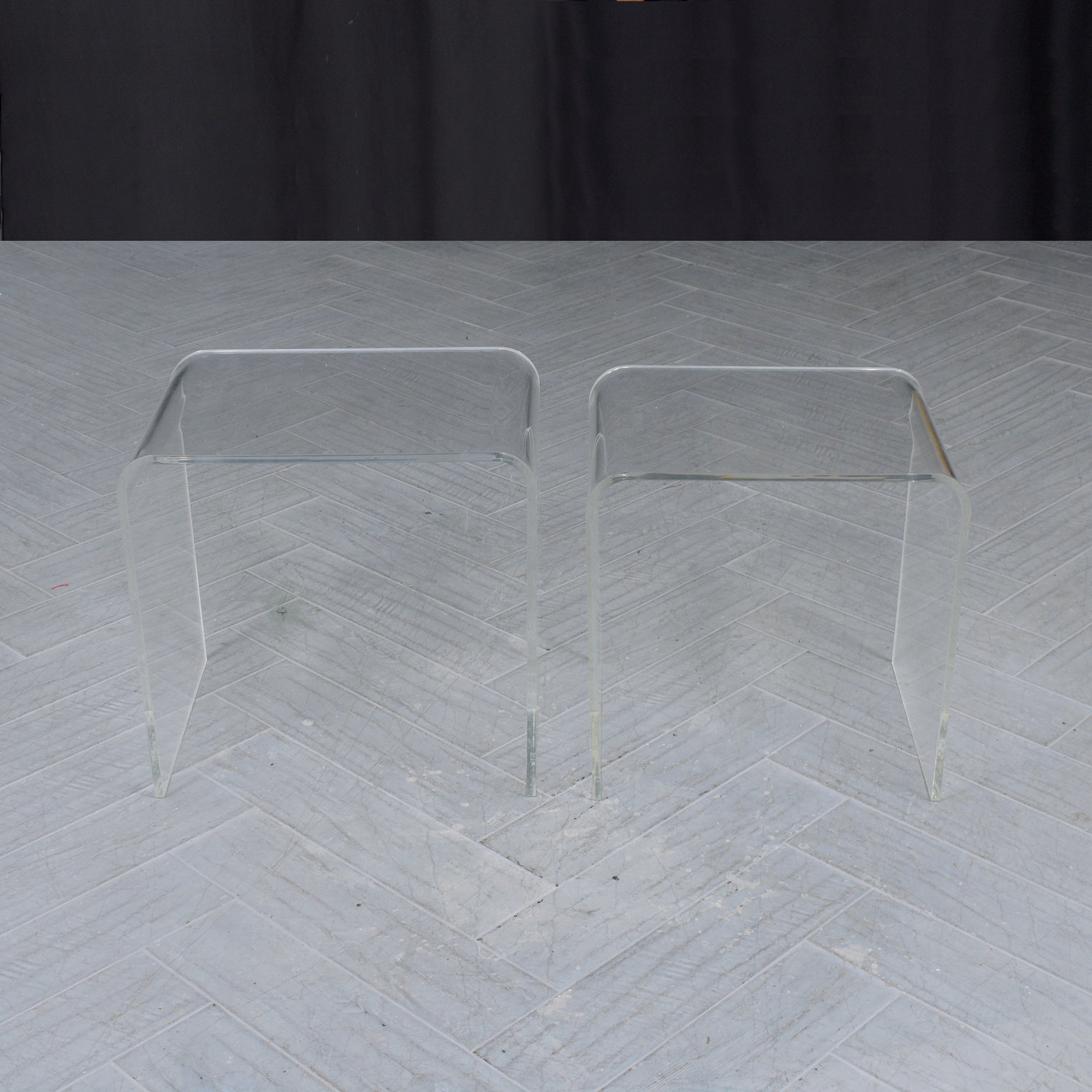 Presenting our stunning mid-century modern nesting tables, carefully crafted from lucite and maintained in great condition. Newly cleaned and polished by our professional in-house team of craftsmen, this pair of vintage side tables showcase a