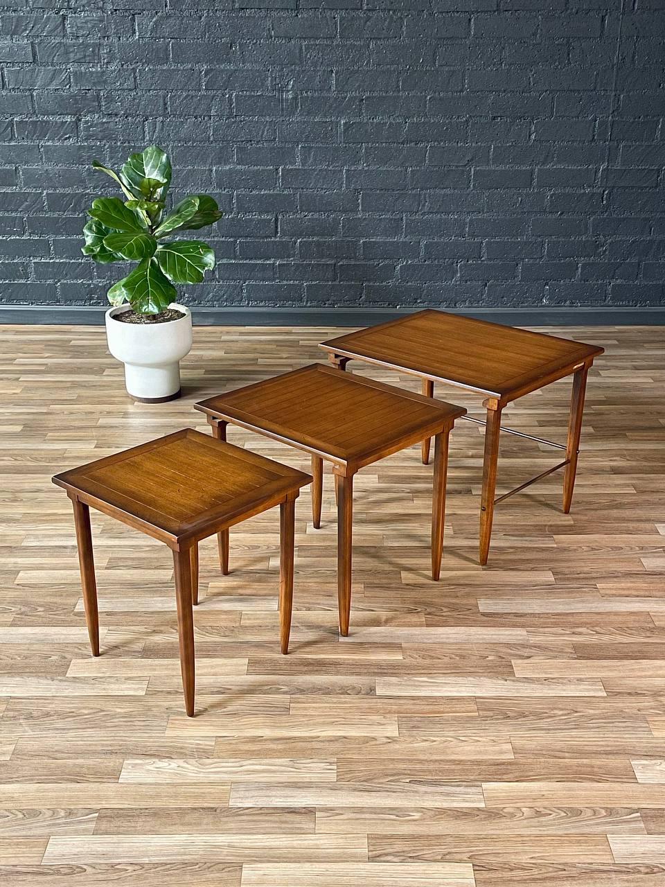 Condition: Original Vintage Condition

Materials: Walnut-Stained Mahogany Wood, Patinated Brass 

A testament to Mid-Century elegance, this set of “Sophisticate” nesting tables by Tomlinson showcases impeccable craftsmanship with a refined balance