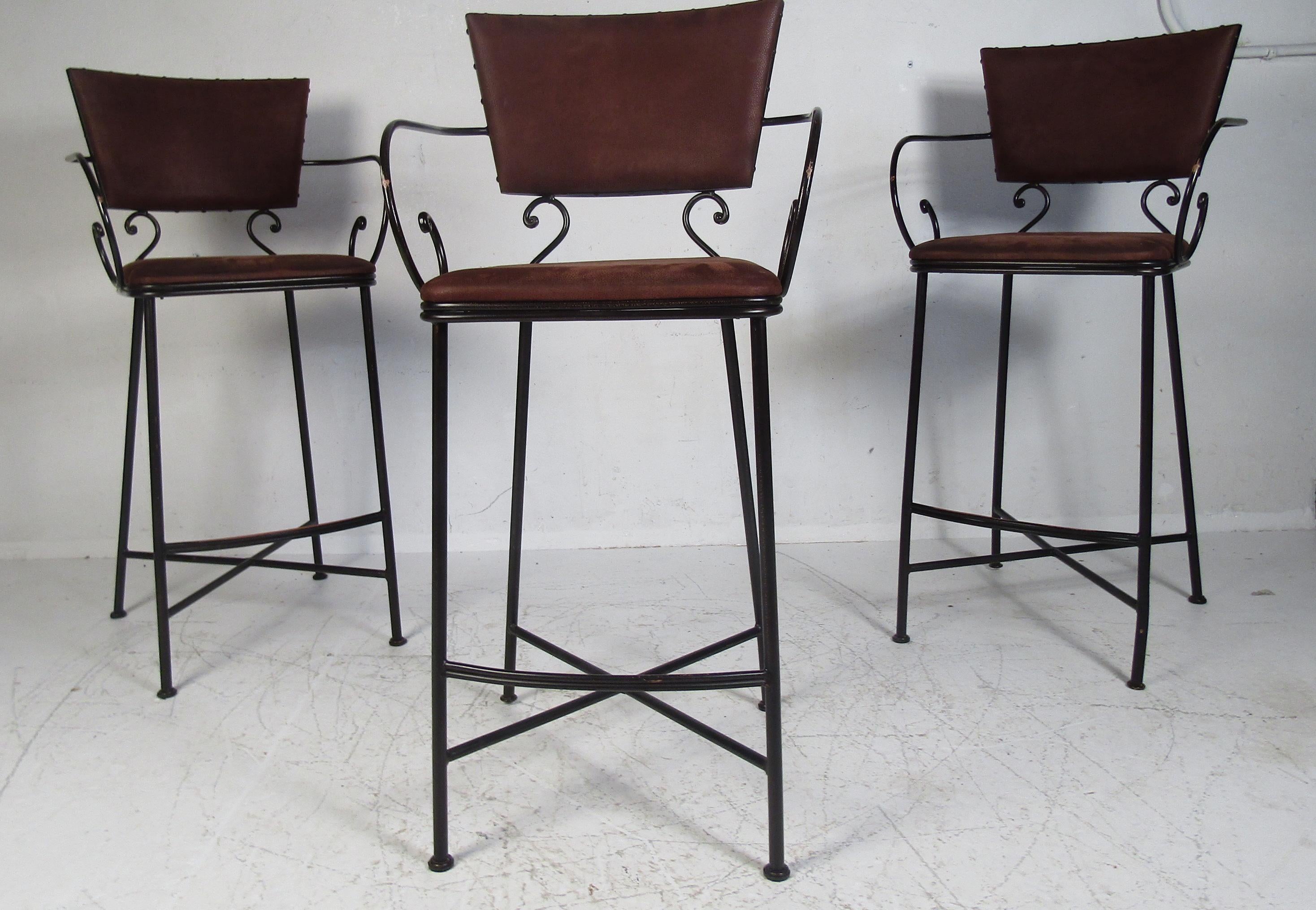A stunning set of metal and leather bar stools with decorative metal bars. Perfect for any office/home/kitchen setting.