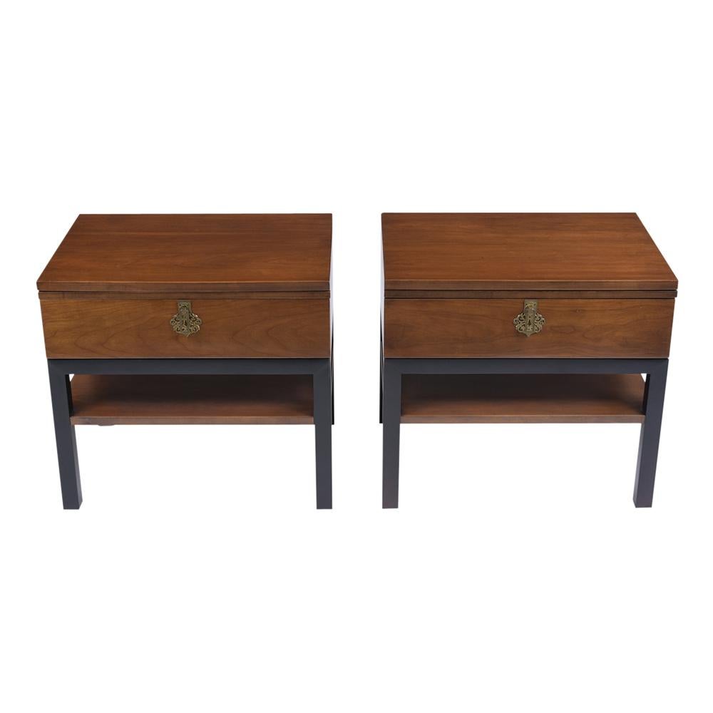 This pair of extraordinary modern nightstands in a manner of Tommi Parzinger has been professionally restored and newly finished in dark walnut & black color combination. These bedside tables feature a top pullout shelf, single drawer with a brass