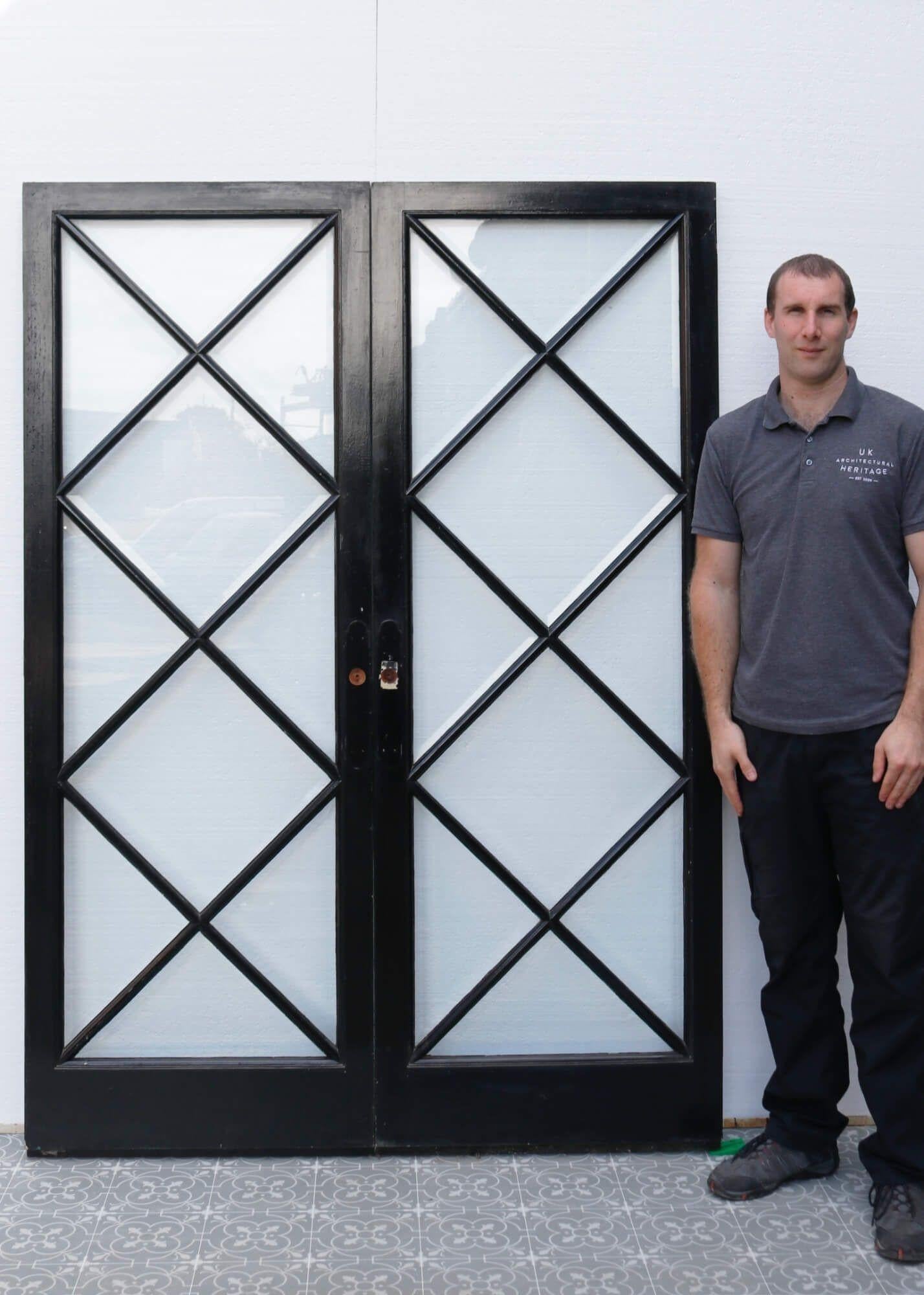 Dating from the 1950s, this pair of reclaimed glazed internal doors make a stylish set of dividing doors. Channelling a mid-century look, they are striking double doors for a modern interior, making a statement with their geometric diamond-shaped,