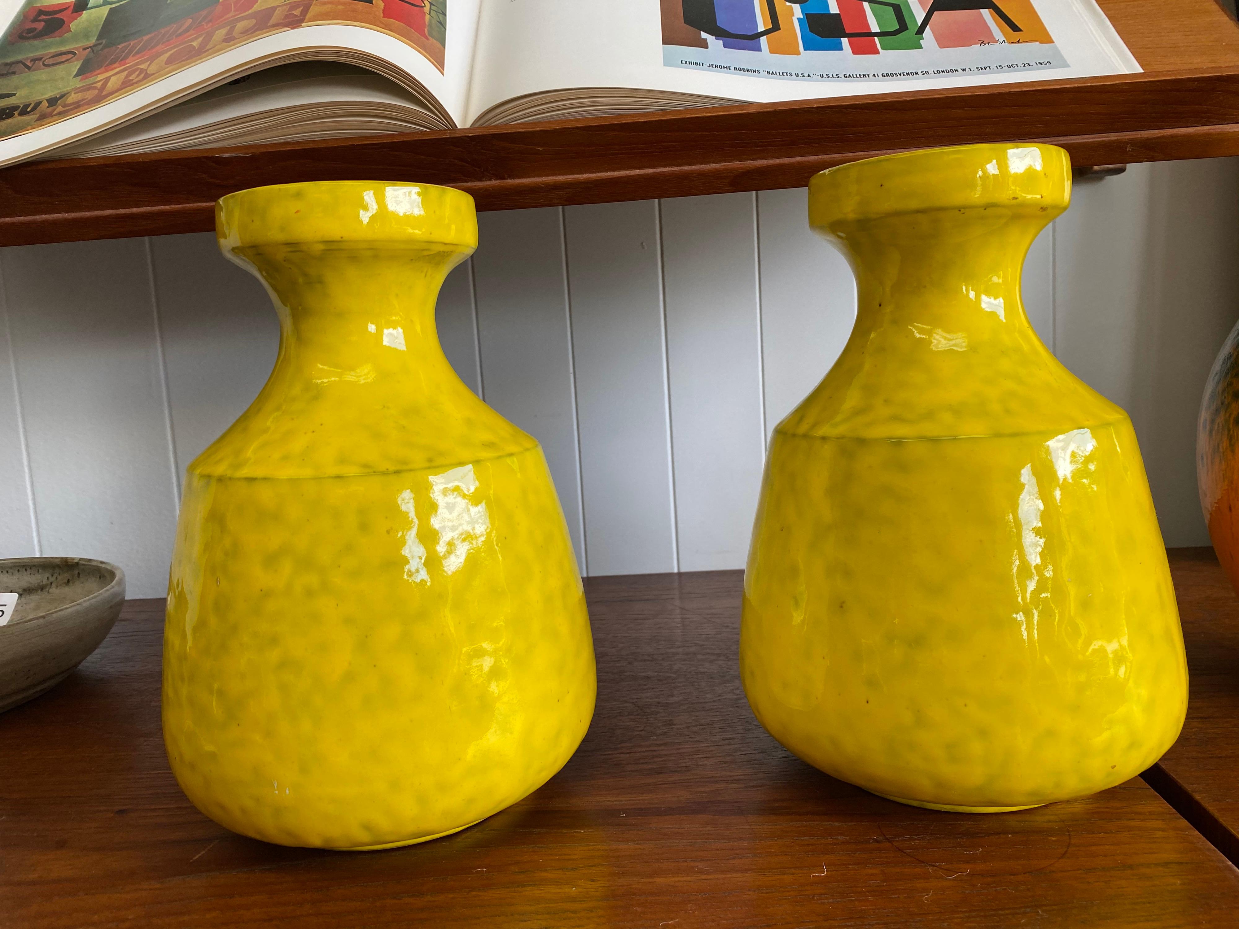 A set of Mid-Century Modern ceramic vases made in Italy by Rosenthal-Netter is signed with paper label. These vibrant yellow vases are in good condition.