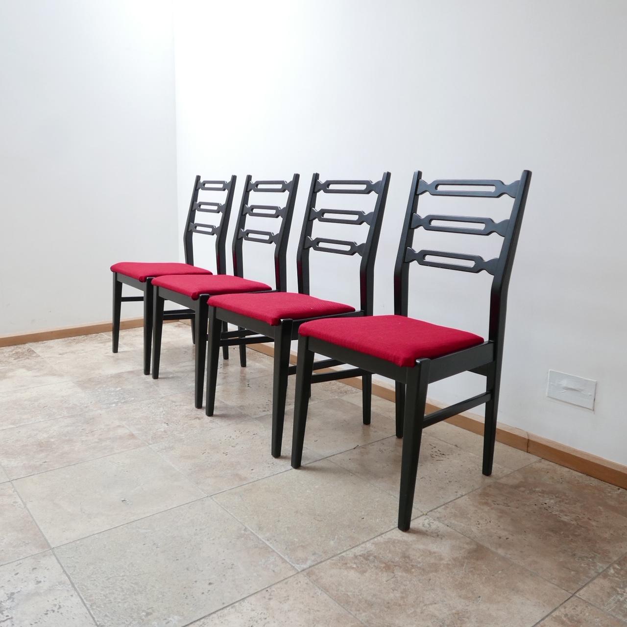 A good looking set of four dining chairs. 

Painted or ebonized wood frames, with some fairly rich upholstery that can be affordably changed on request for a more muted color.

Good condition to the wood and the upholstery. 

Dimensions: 45 W