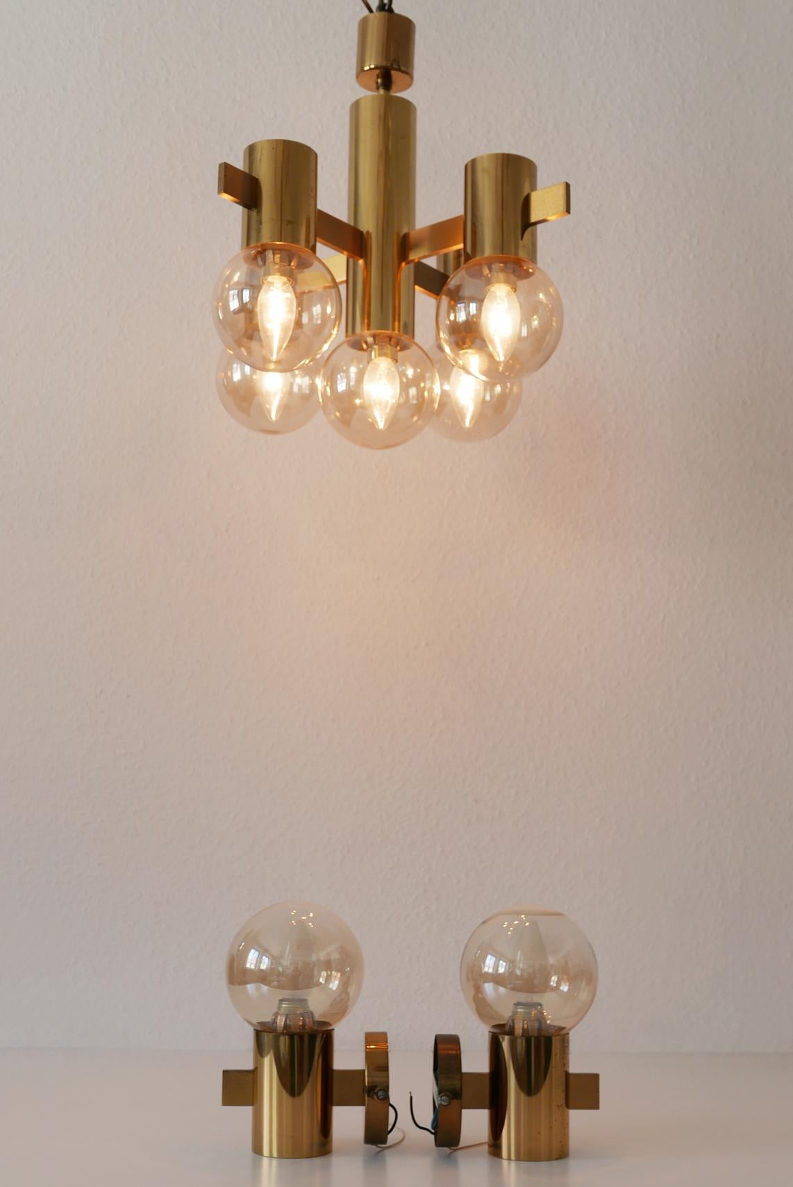 Set of elegant Mid-Century Modern chandelier and wall lamps. Designed probably by Hans-Agne Jakobsson for Markaryd, Sweden in 1960s.

Executed in massive brass. The chandelier needs 5 x and each wall lamp 1 x E14 Edison screw fit bulb.They are