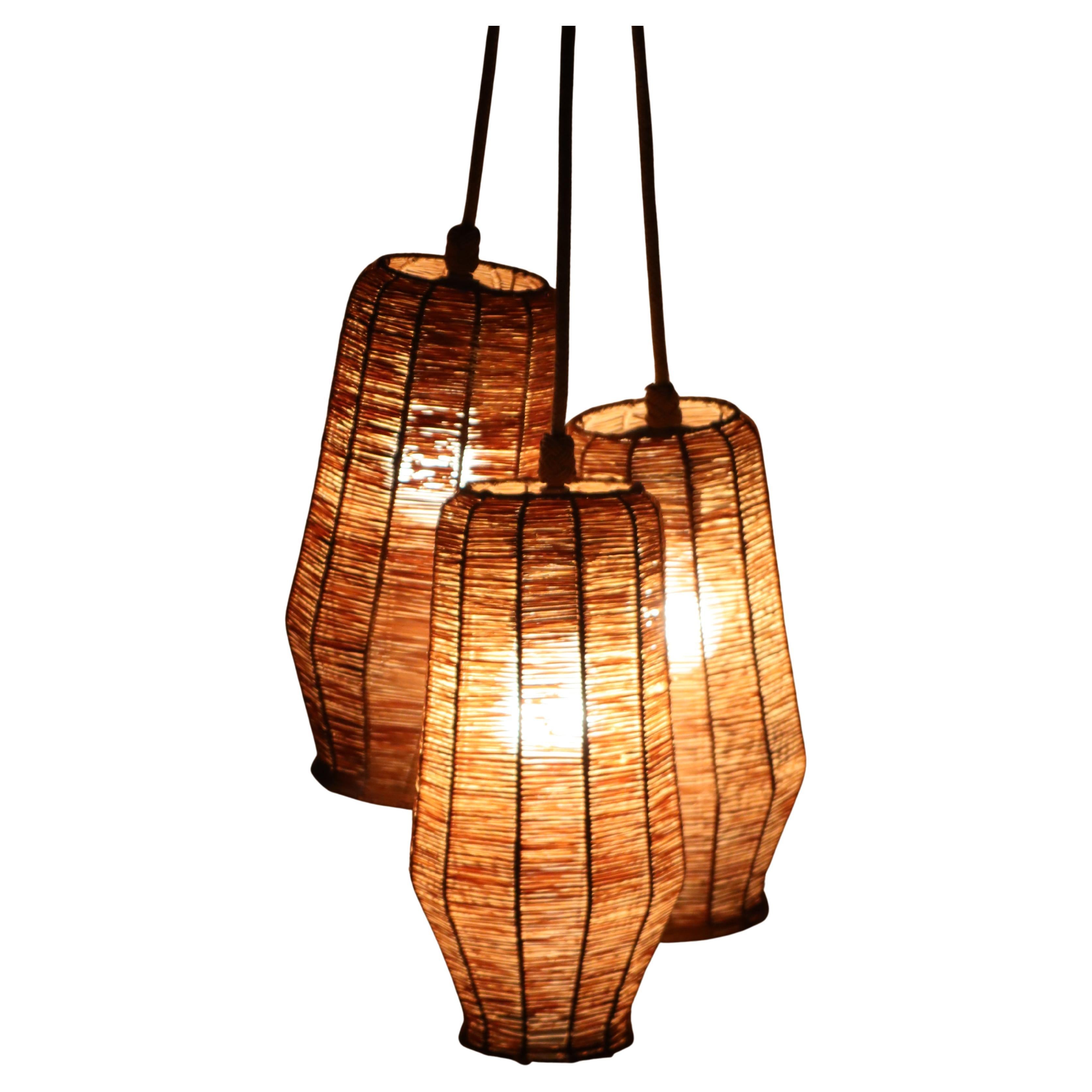 We are so excited to tell you about this beautiful set of three handcrafted hanging lamps! It's a wonderful and rare find. We've made sure to replace the power cords, and we've been really careful to make sure everything feels authentic. The lamps