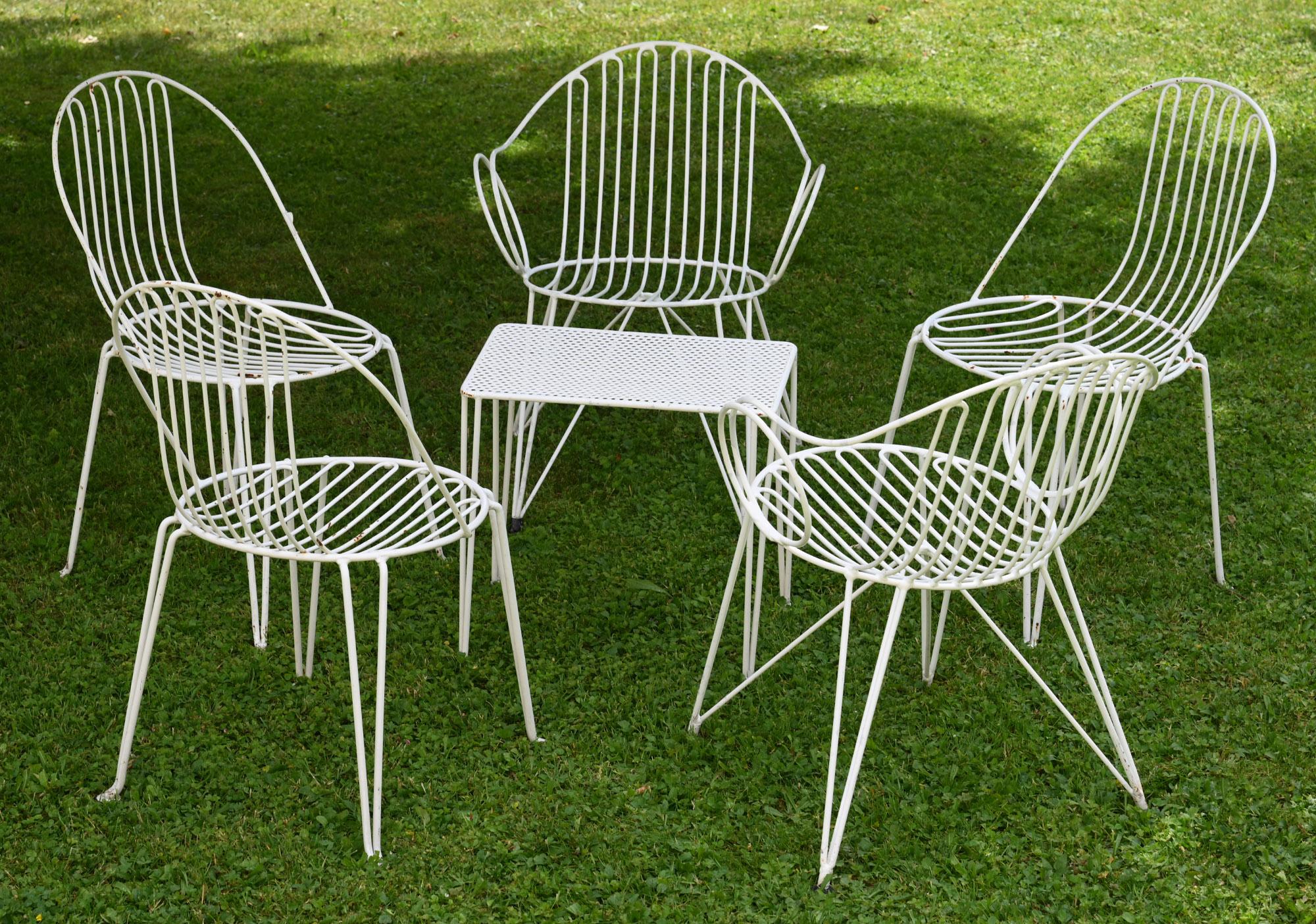 Set of midcentury garden chairs and table, iron, white painted, german

Wonderful set of 2 armchairs, 3 chairs and a small cocktail table. The paint of some is worn and a little bit rusted. They are in typically 1950s style.