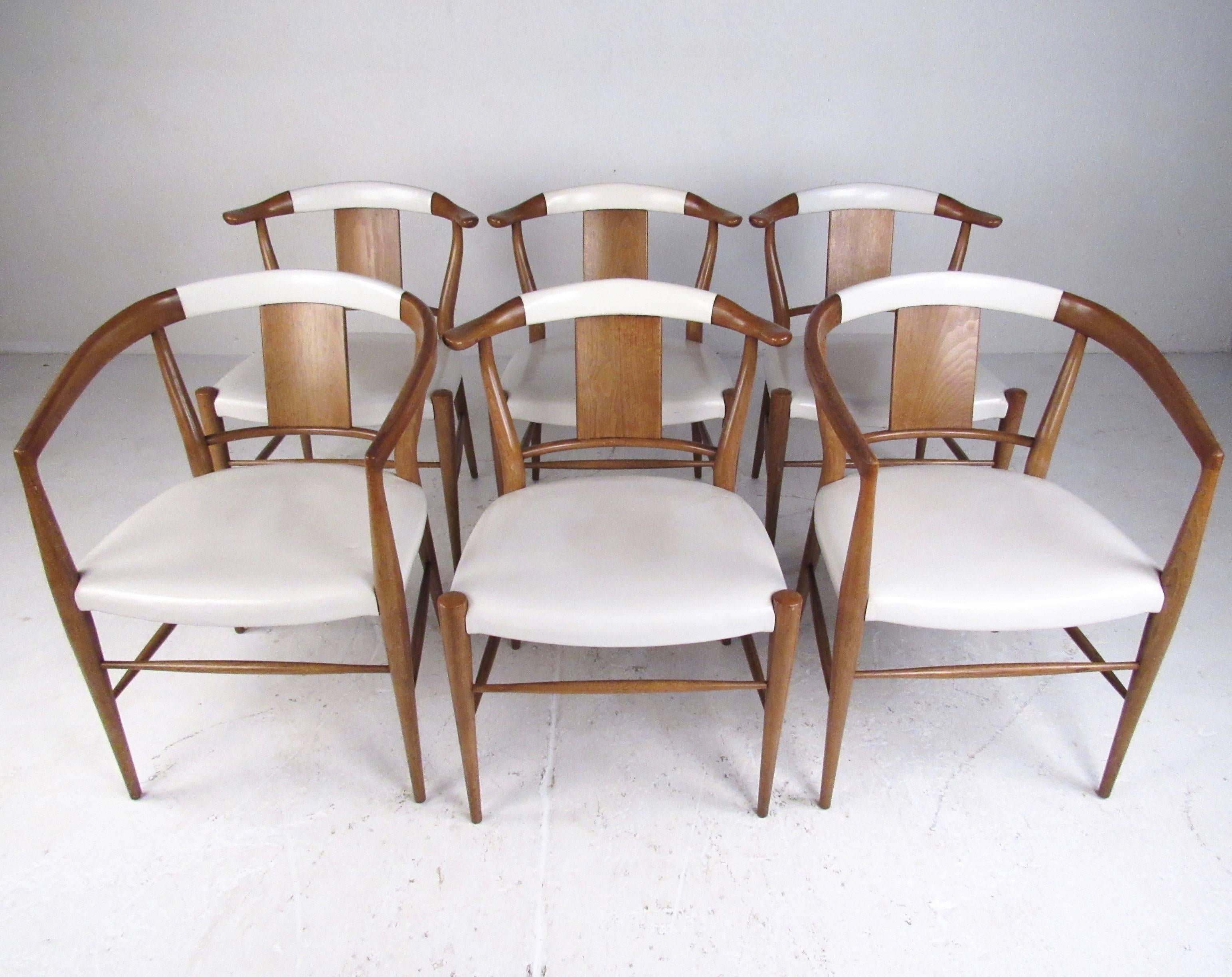 This stylish set of six vintage modern dining chairs by Heritage-Henredon of North Carolina feature solid walnut construction with upholstered leather seats. Mid-Century Modern design, sculptural seat backs, and quality American construction adds to