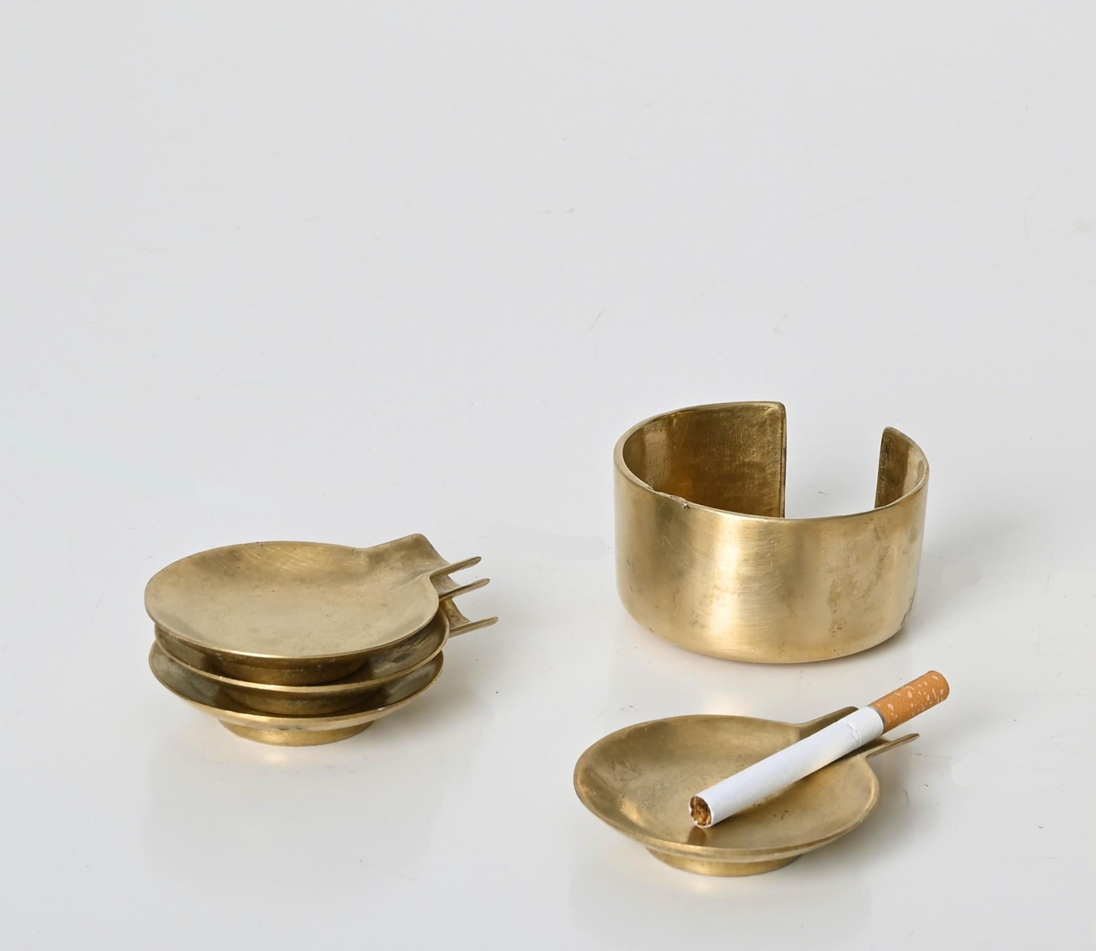 Beautiful set of four stackable ashtrays in solid brass. This elegant and versatile set was produced in Austria during the 1950s after Adnet.

The light reflection of the solid brass and the four ashtrays that can be stacked into the main structure