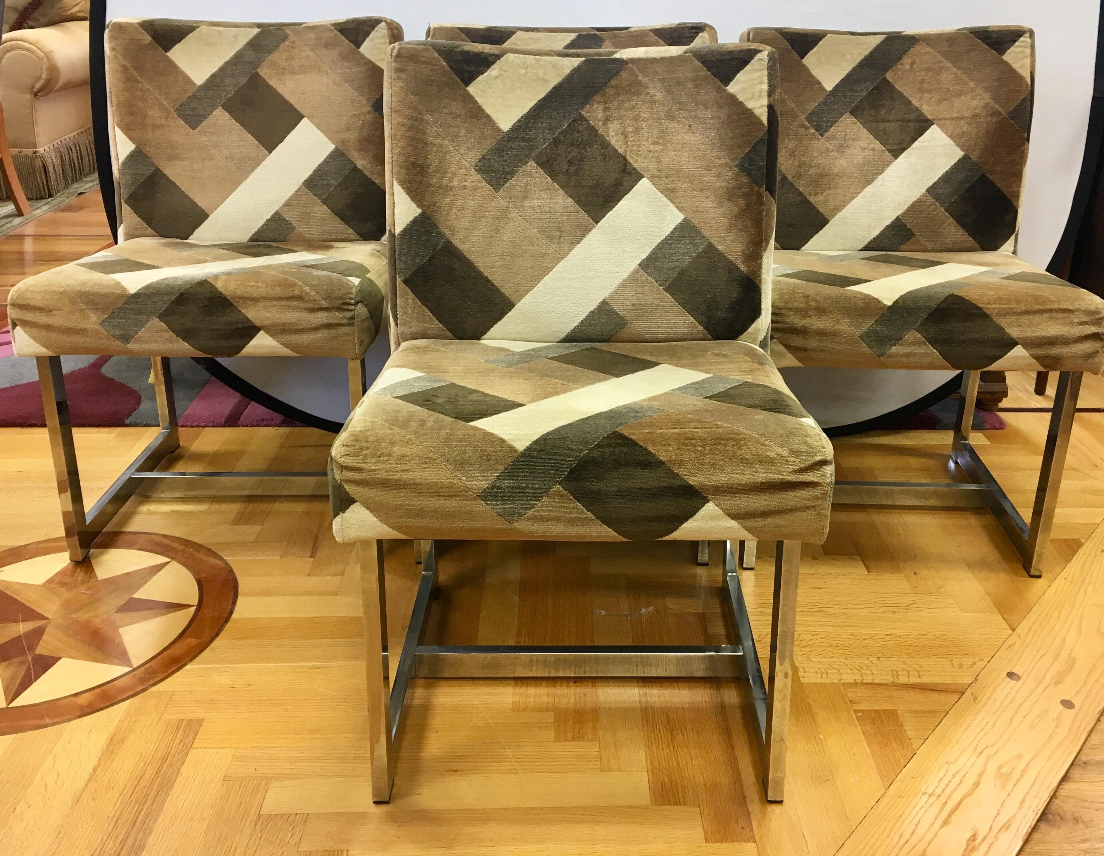 Perfect for your dining room or kitchen table, or in a study, this set of four matching Milo Baughman style chairs feature original Jack Lenor Larsen fabric which is still in decent shape.