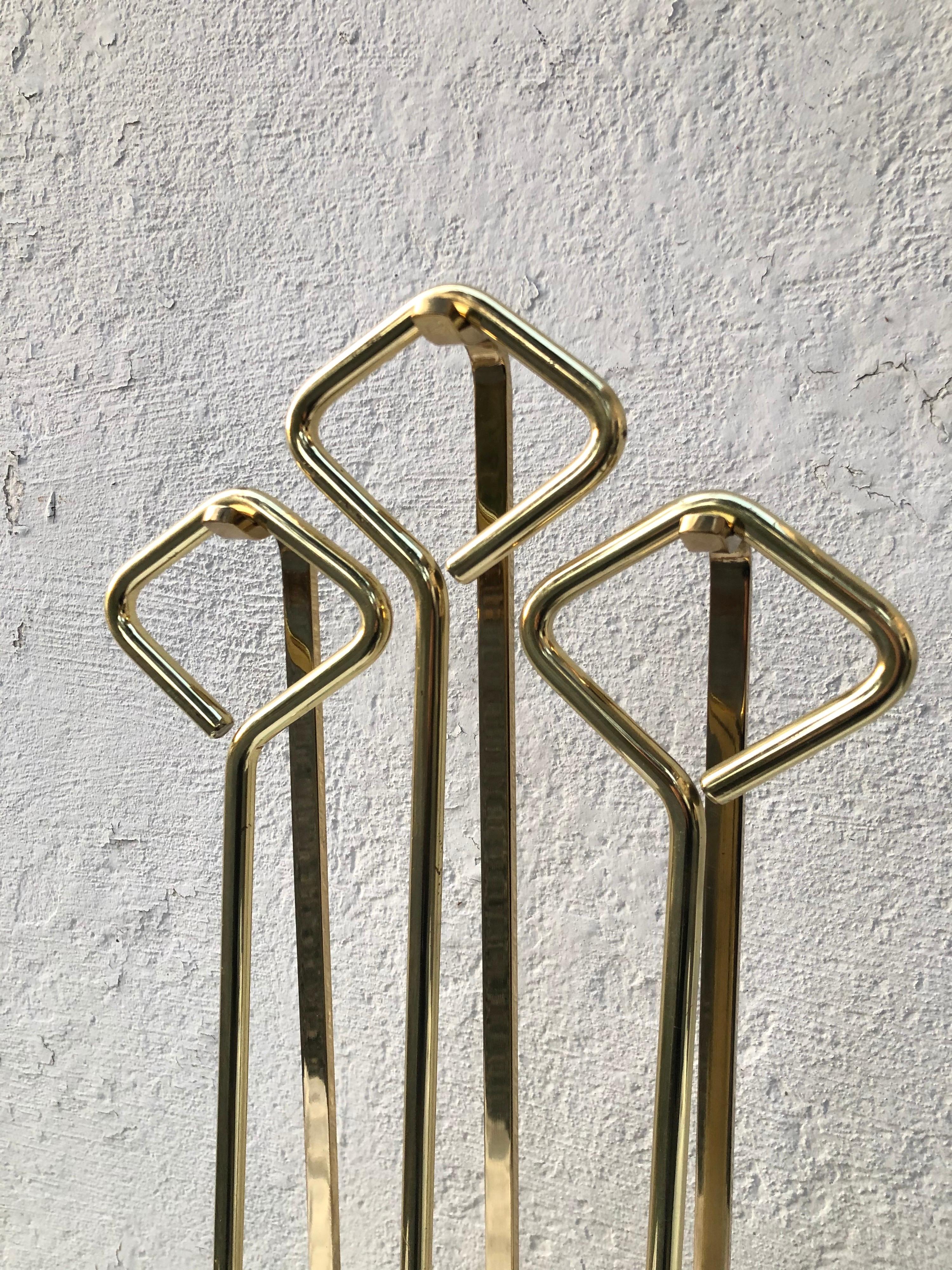 Set of Modern brass and glass fireplace tools.