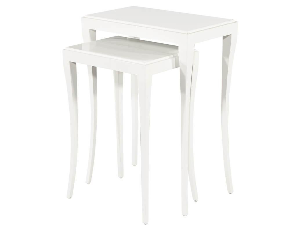 Set of modern white nesting tables. Modern Deco inspired featuring mahogany woods and sleek curved legs. Custom finished in hand polished white lacquer. Also available in black.

Price includes complimentary curb side delivery to the continental