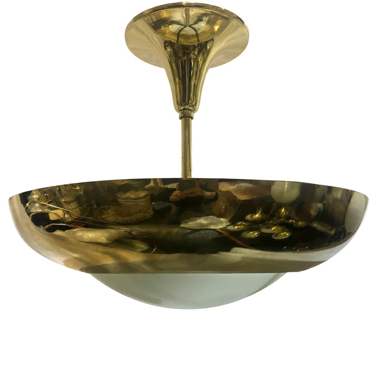 Set of six French circa 1960's polished bronze light fixtures with milk glass insets. Sold individually.

Measurements:
Diameter: 20