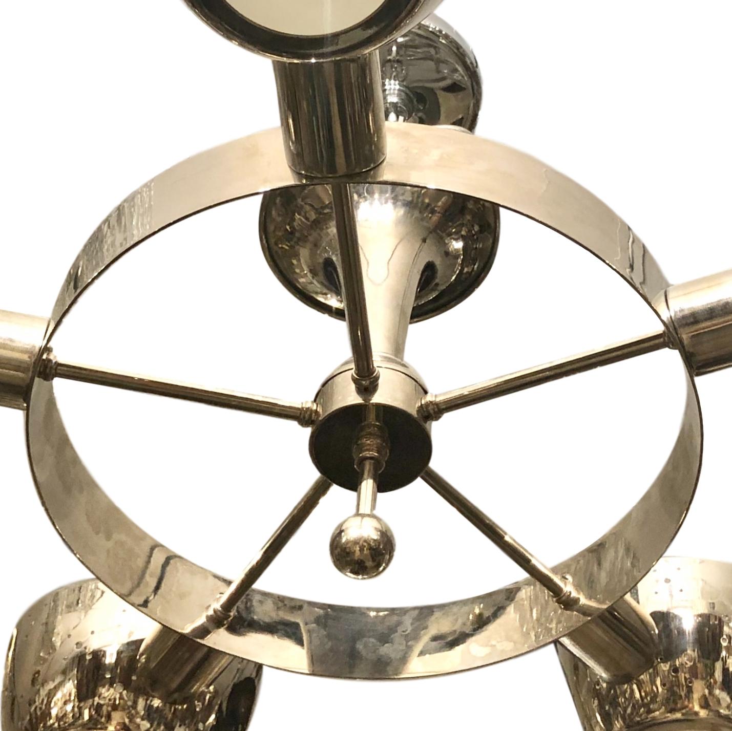 A set of four circa 1960's Italian nickel-plated five-arm light fixture with frosted glass insets. Sold individually.

Measurements:
Current drop: 18