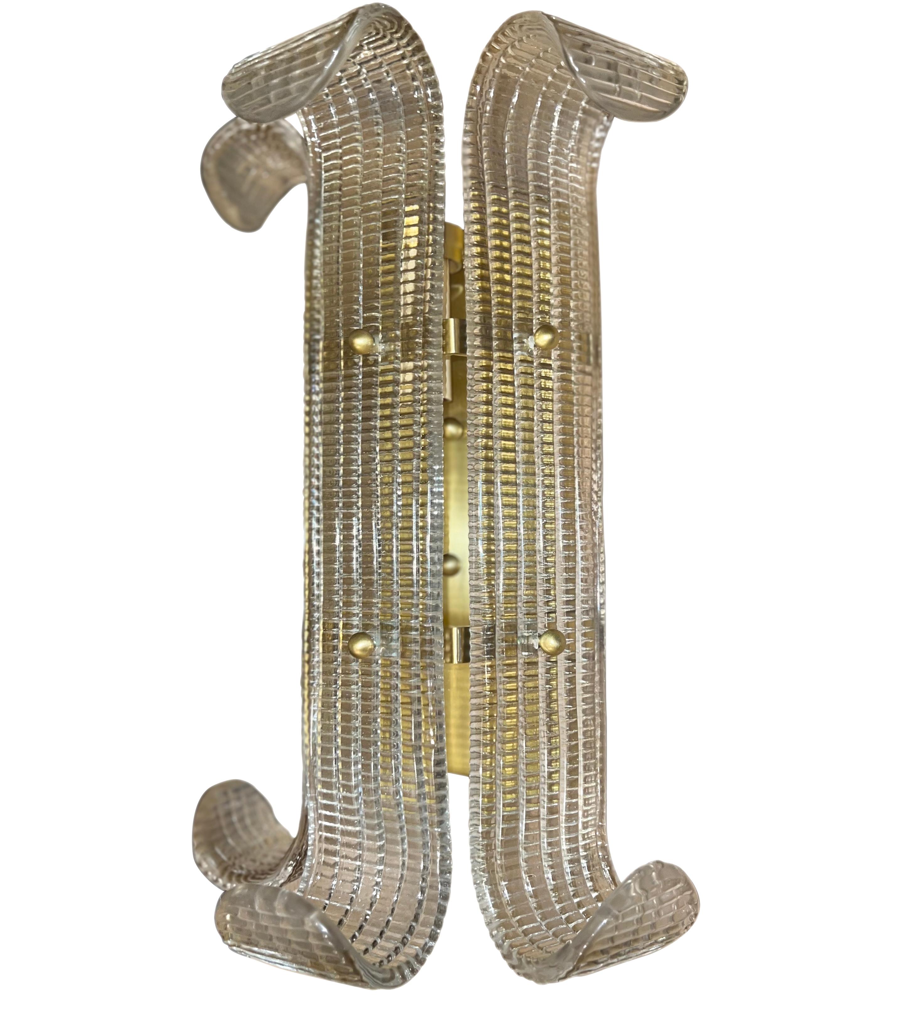 A set of four Italian circa 1960's molded glass sconces with interior lights. Sold in pairs.

Measurements:
Height: 15.5