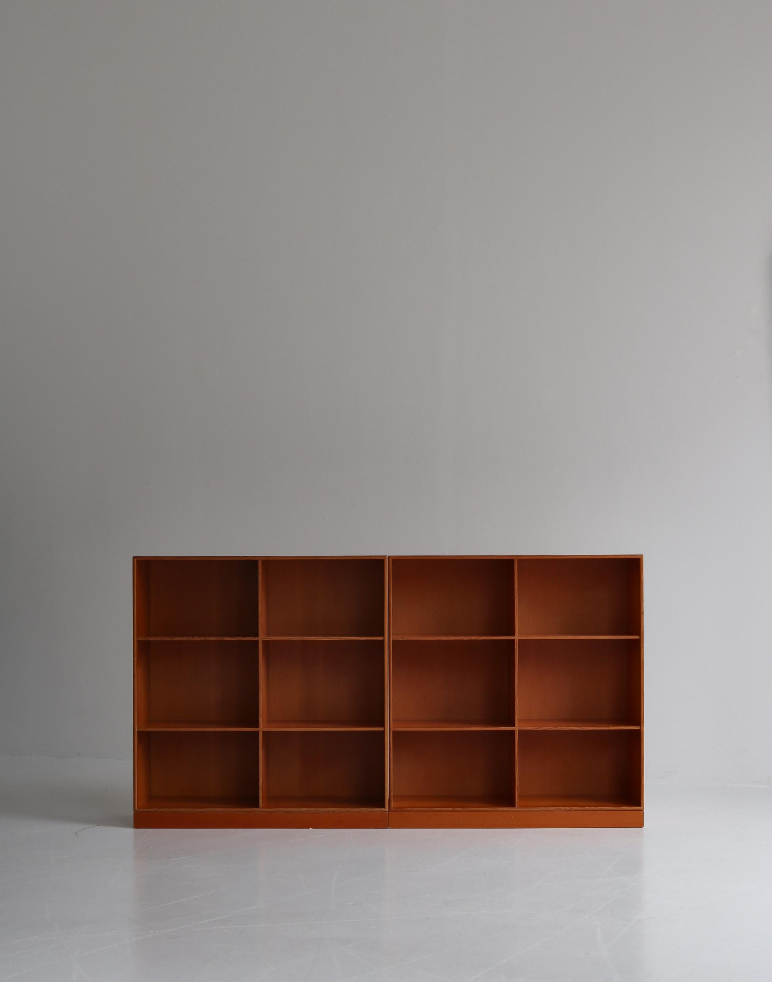 A pair of original Mogens Koch bookcases with two bases. The cases were executed at cabinetmaker Rud Rasmussen in solid Oregon pine in the 1970s. Marked by maker.

Mogens Koch's bookcase system was designed in 1944 and became a symbol of Nordic