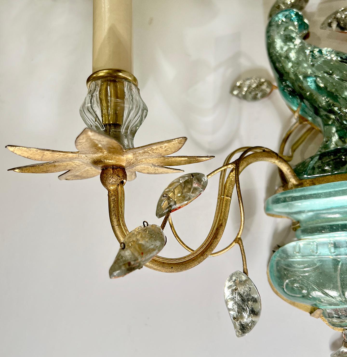 A pair of circa 1960's French gilt metal two-arm sconces with molded glass parrot and leaves. 

Measurements:
Height: 14