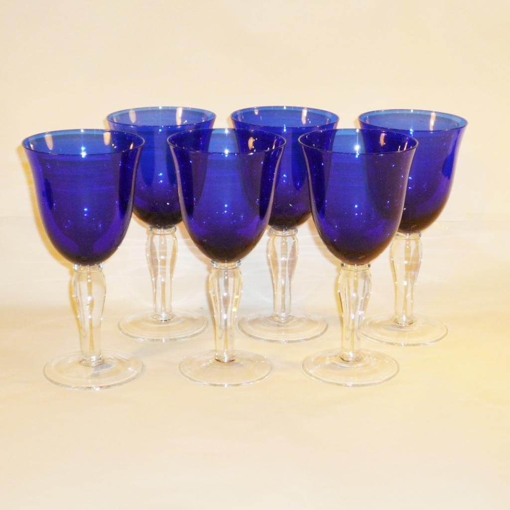 Attractive set of cobalt glasses for wine or water. The glasses are slightly different due to the craftsmanship. They each consist of three parts, remarkable is the approach of the stand plate, which was obviously pierced and then put on the hot