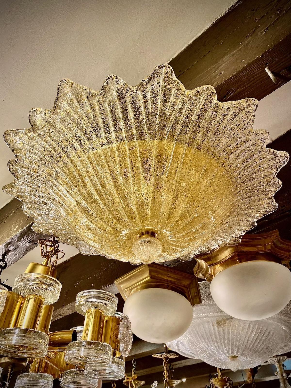 A set of six circa 1940's Italian Murano glass flush mounted light fixture with three interior lights. Sold individually.

Measurements:
Drop: 7