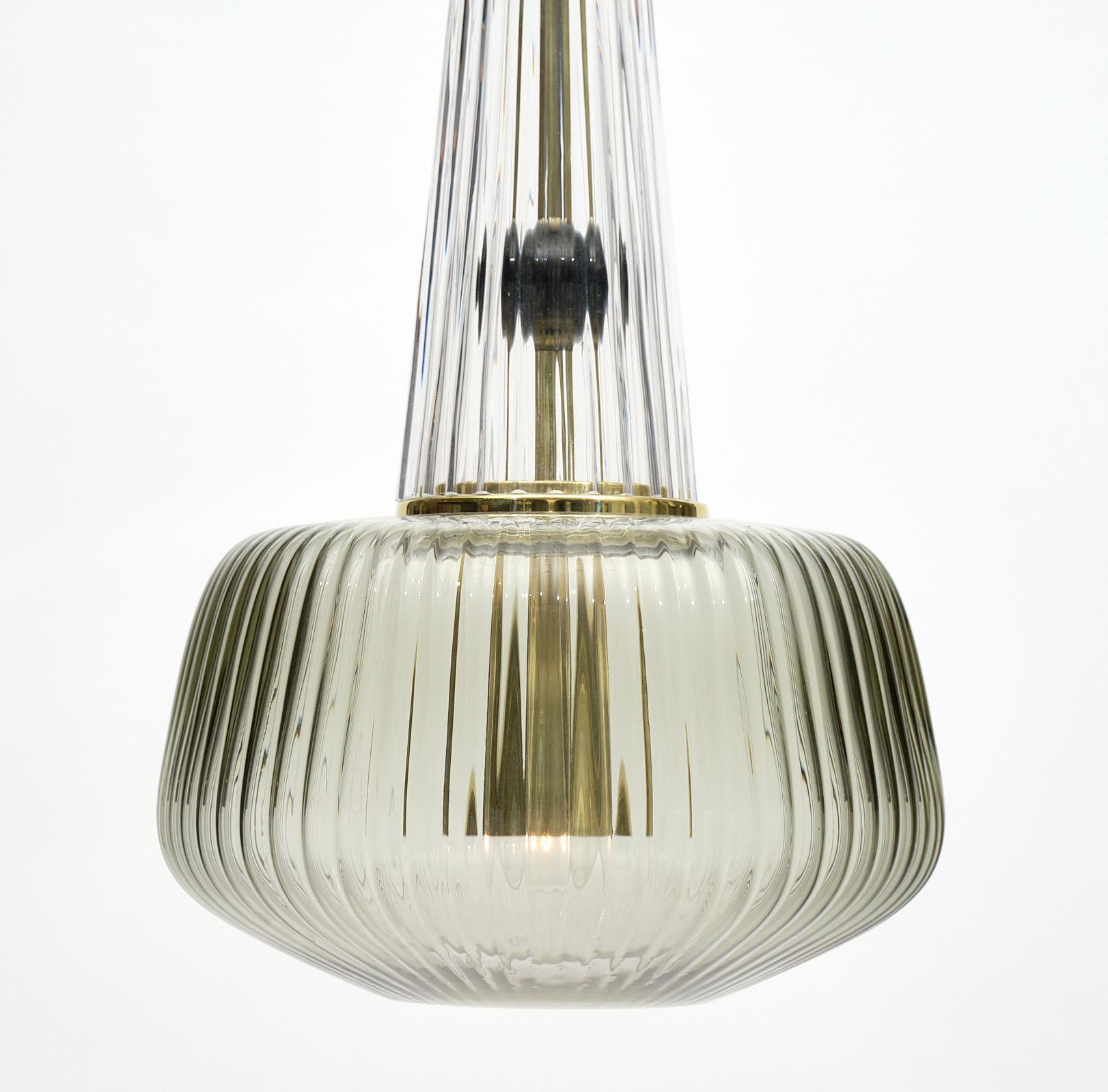 Set of Murano glass ridged pendants in the style of Ettore Sottsass. We have two sets of these beautiful fixtures available and each includes a green fixture, a smoke fixture, and a pink fixture. They have been newly wired to fit US standards. The