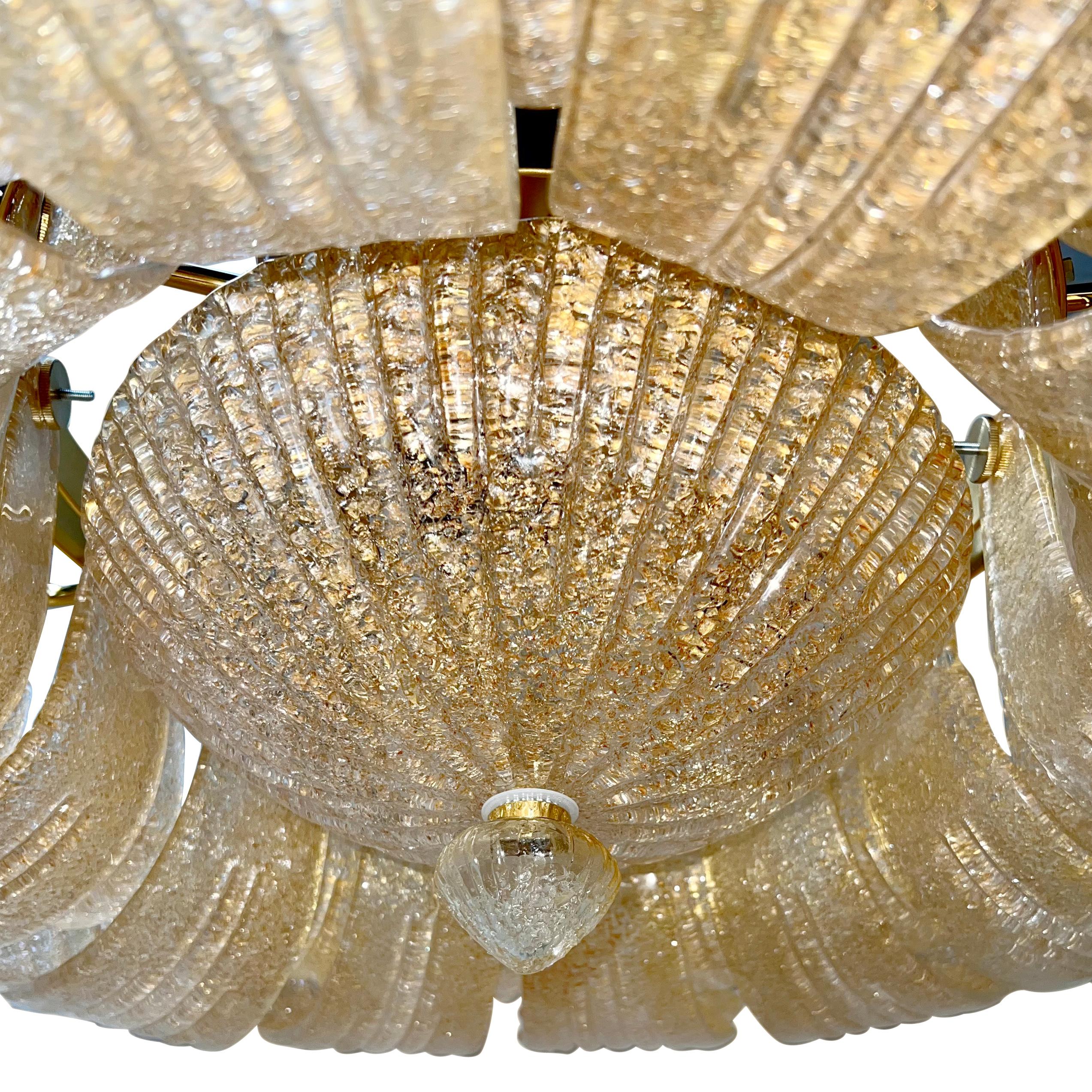 A set of three circa 1960’s Murano clear and gold hand-blown glass semi-flush pendant light fixtures with 10 Edison interior lights in a floral motif. Sold individually.

Measurements:
Drop: 11