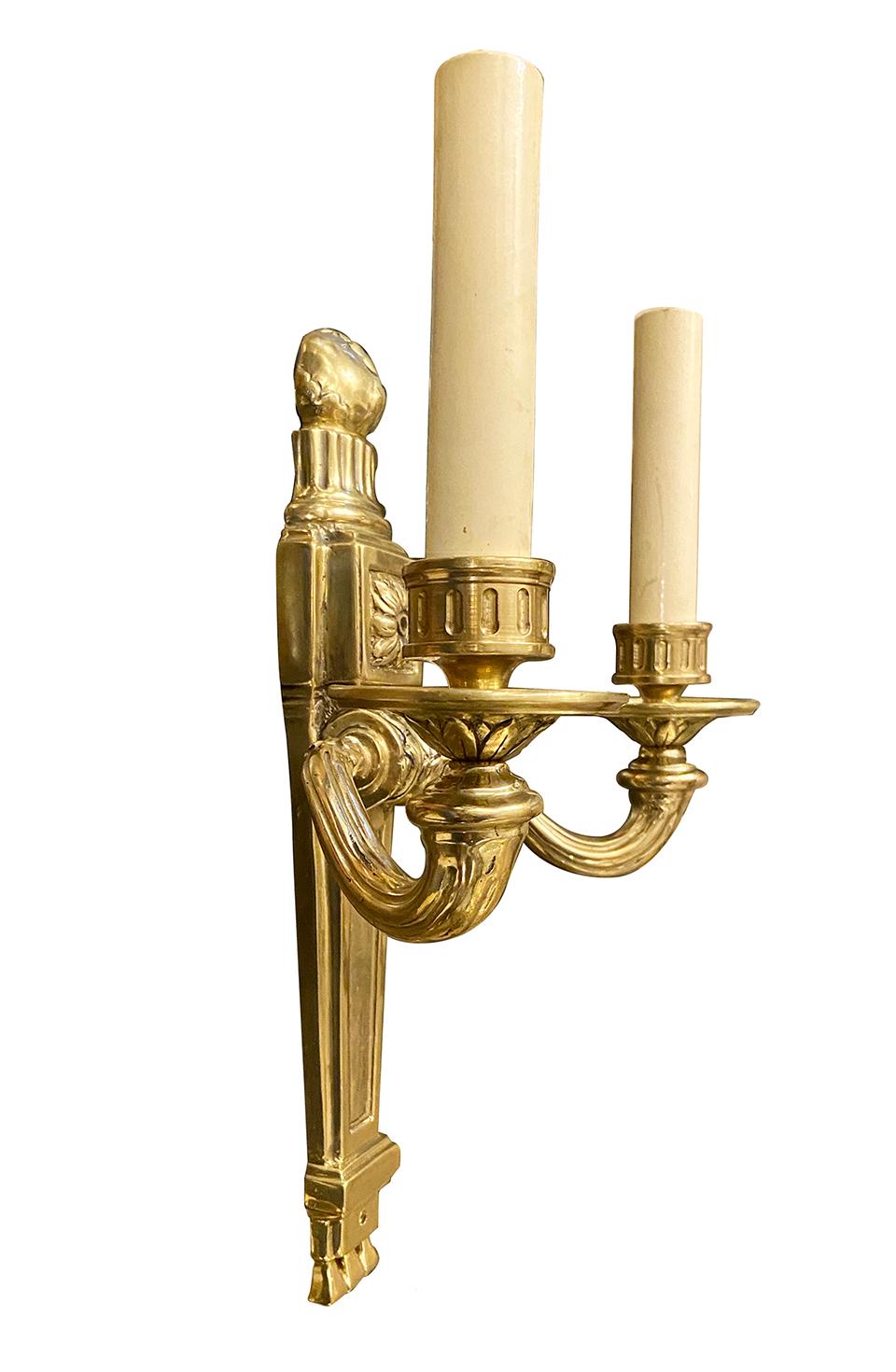 Set of four circa 1920s American neoclassic-style gilt bronze sconces with double arm and with 