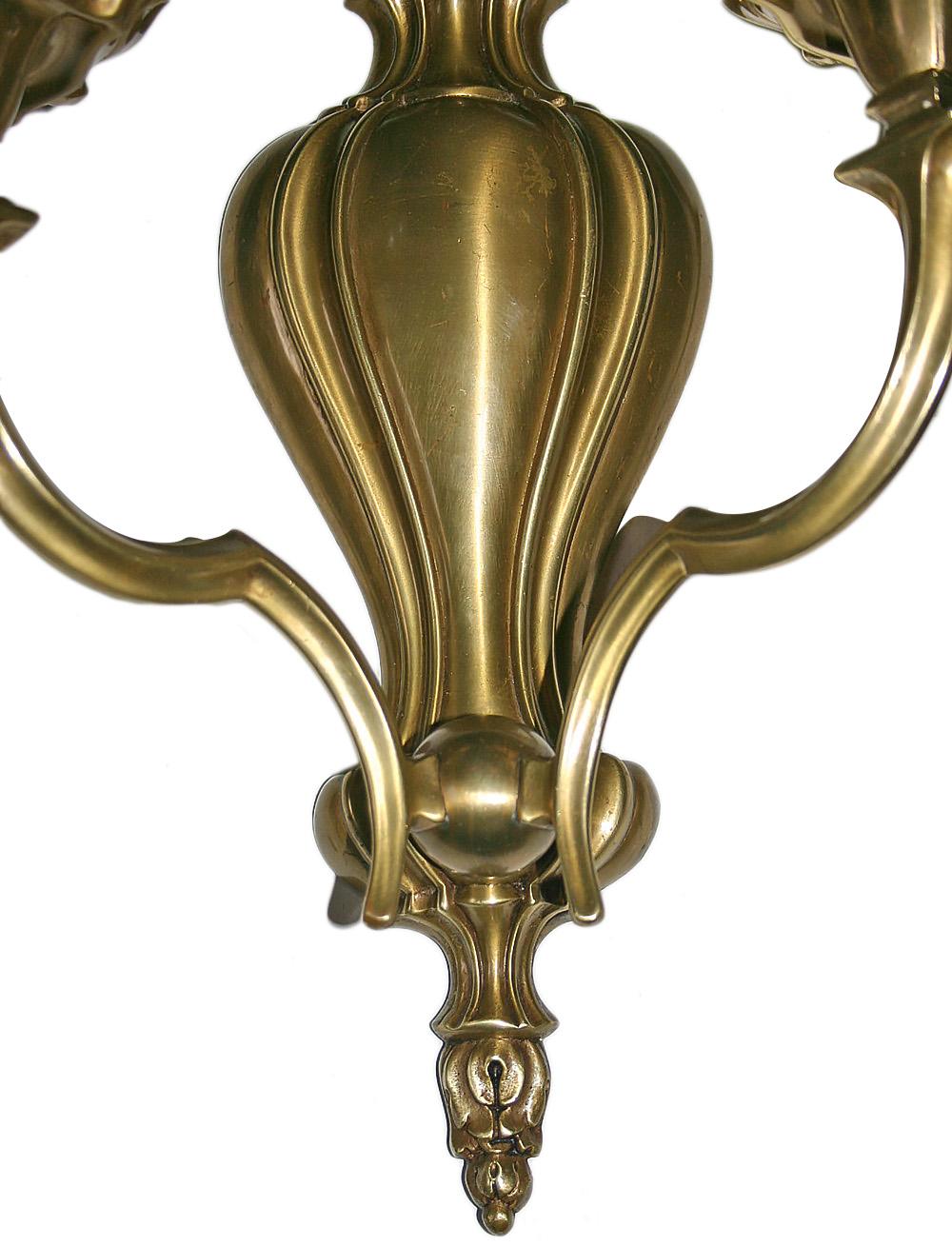 Set of twelve American neoclassic style circa 1940s bronze two-arm sconces with double light. Sold in pairs.

Measurements:
Height 15