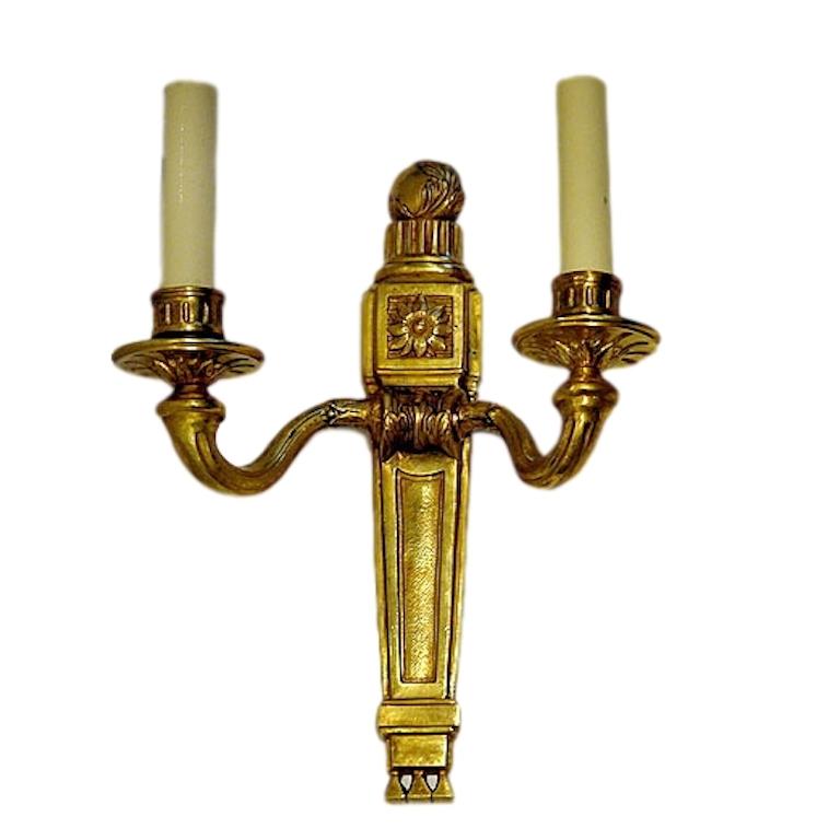 Set of four circa 1920s American neoclassic-style gilt bronze two-arm sconces with original patina. Sold per pair.

Measurements:
Height 12.5