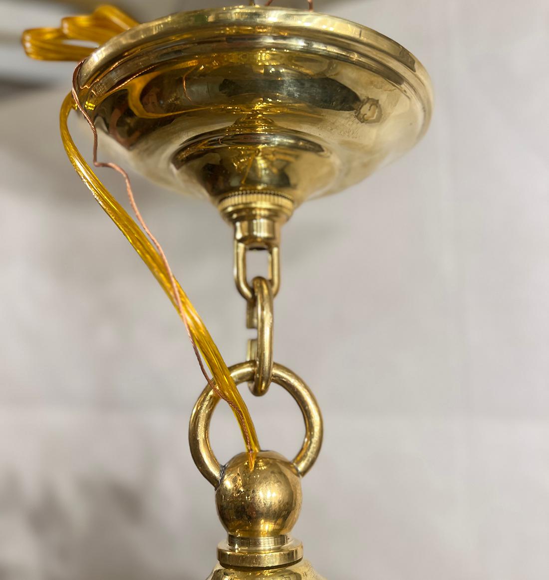 A set of four circa 1950's French cast bronze globe lanterns with three interior lights each. Sold individually.

Measurements:
Current drop: 24
